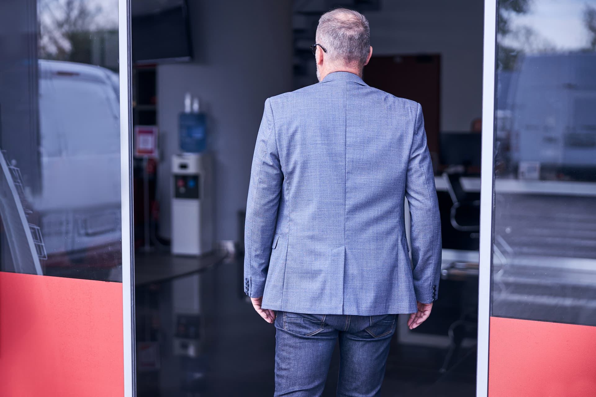 Man entering sliding door entrance for business