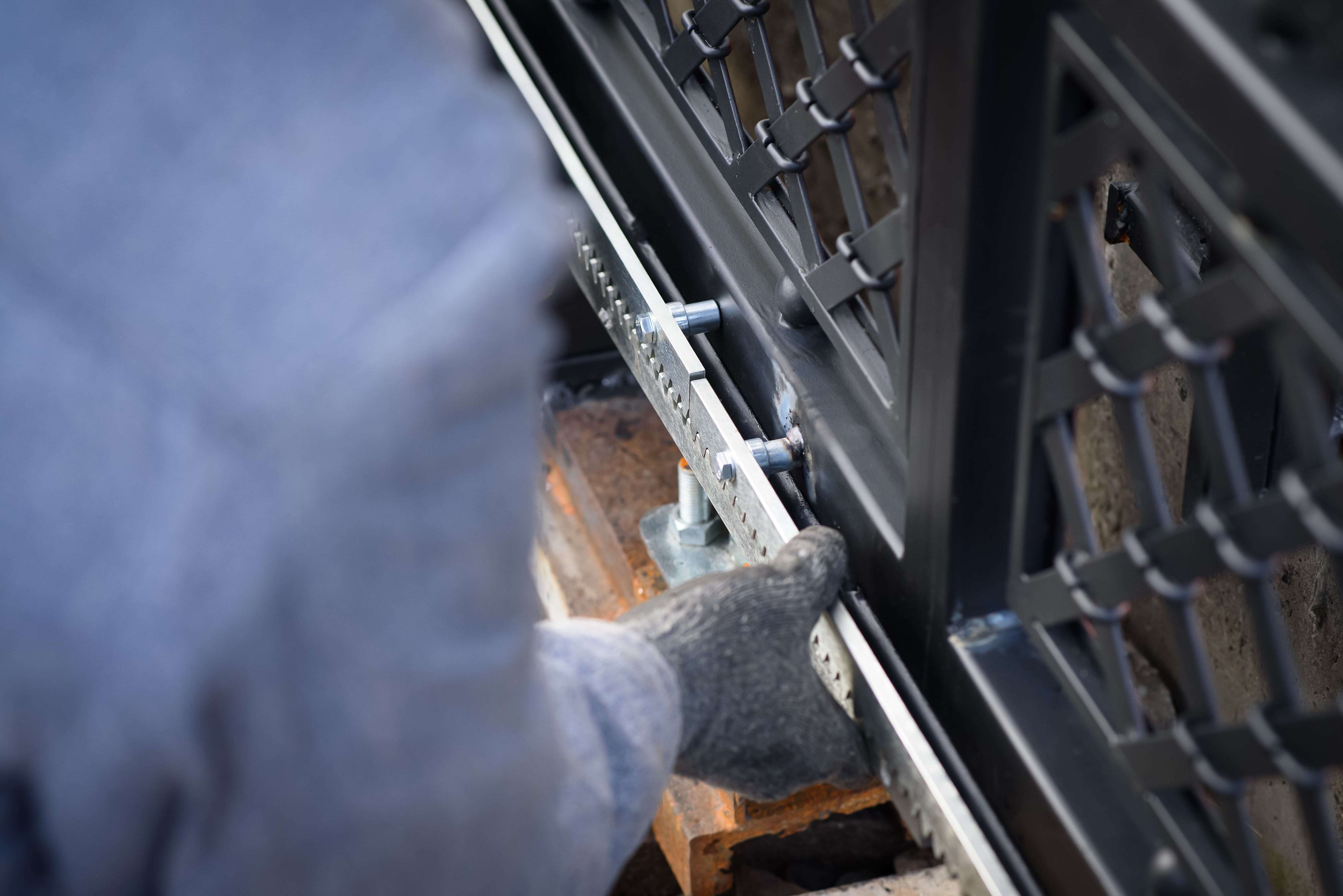 technician maintaining sliding gate