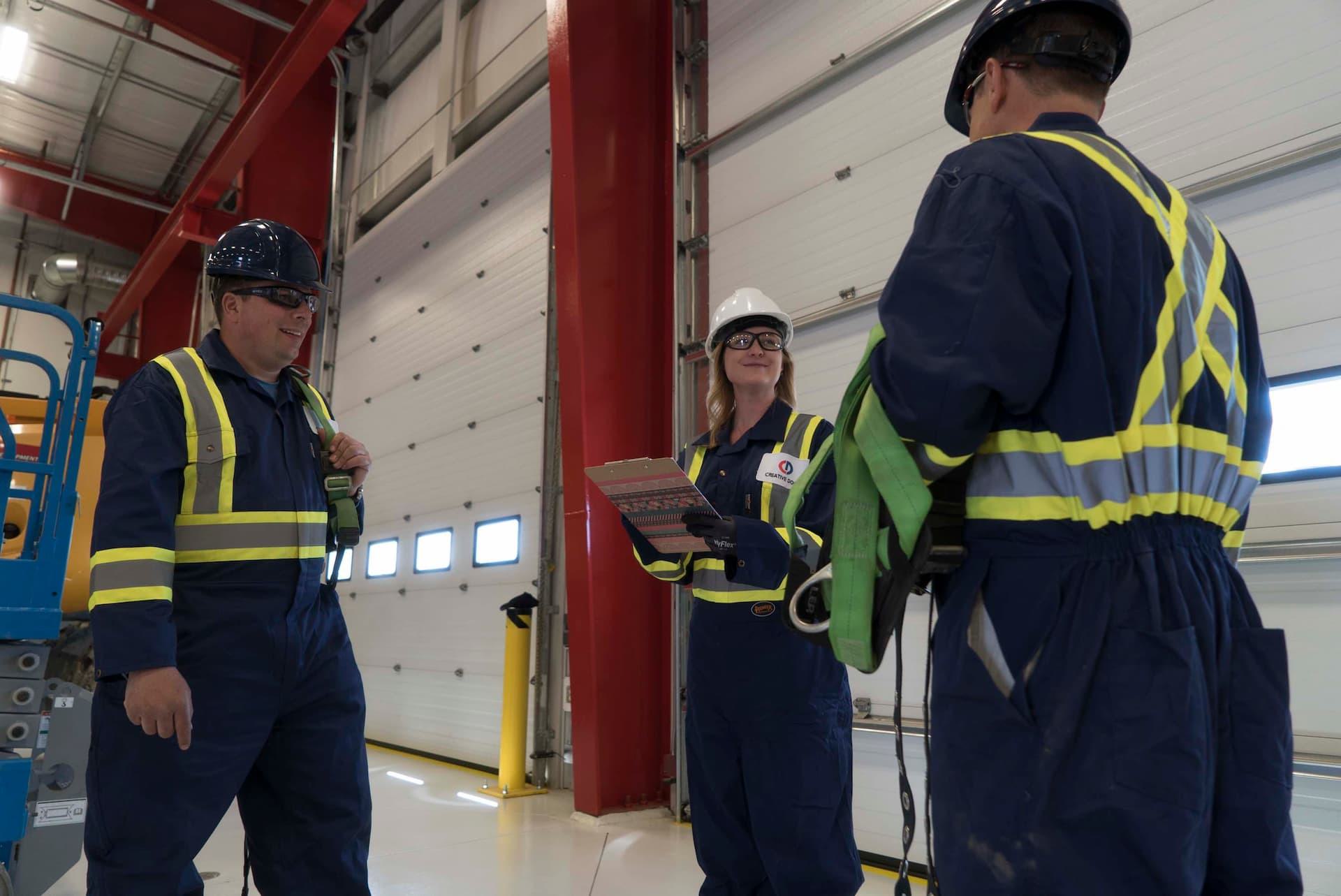 Technicians from Creative Door Services discussing commercial door maintenance