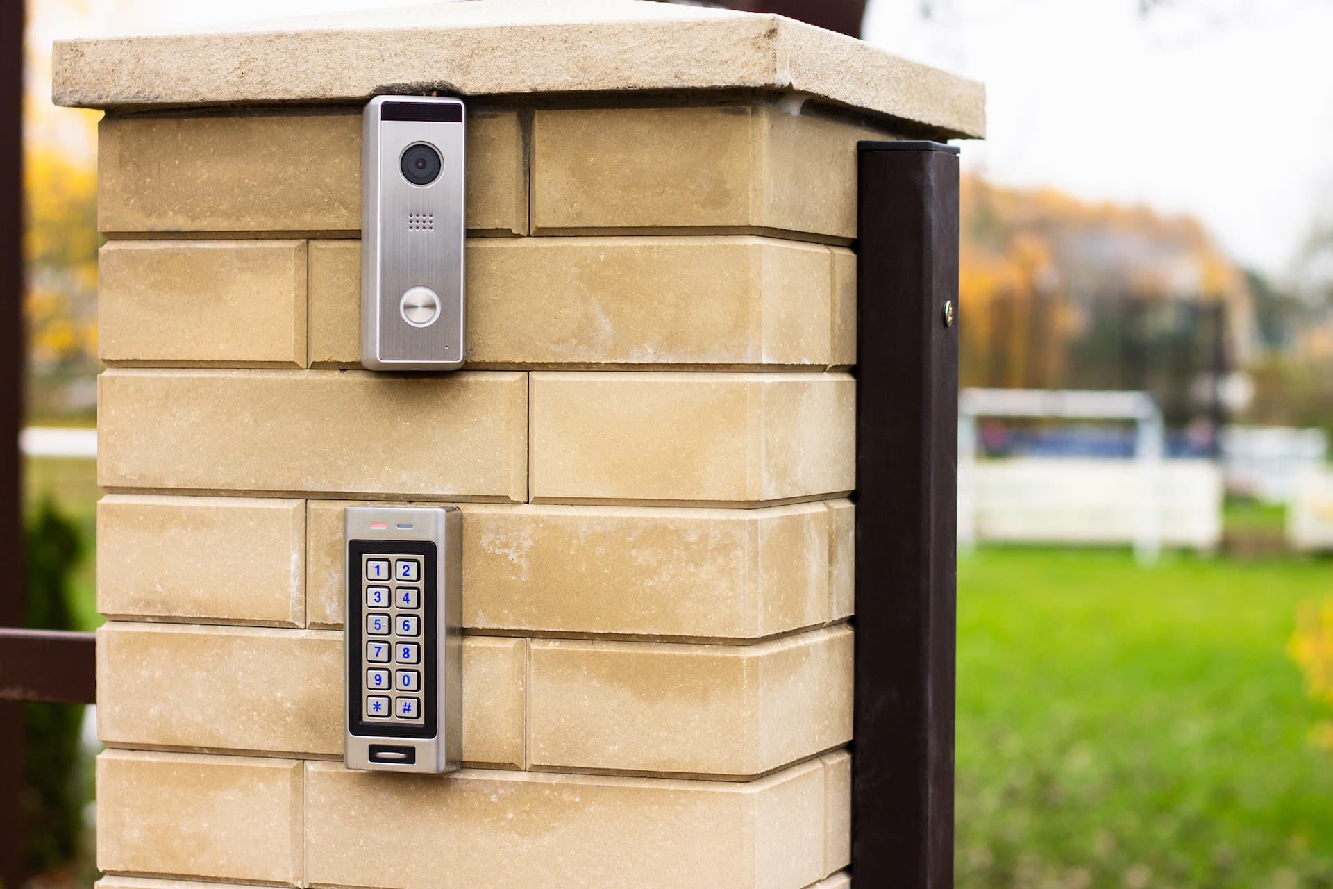 Video intercom and keypad gate access system installed on brick post for secure entry control