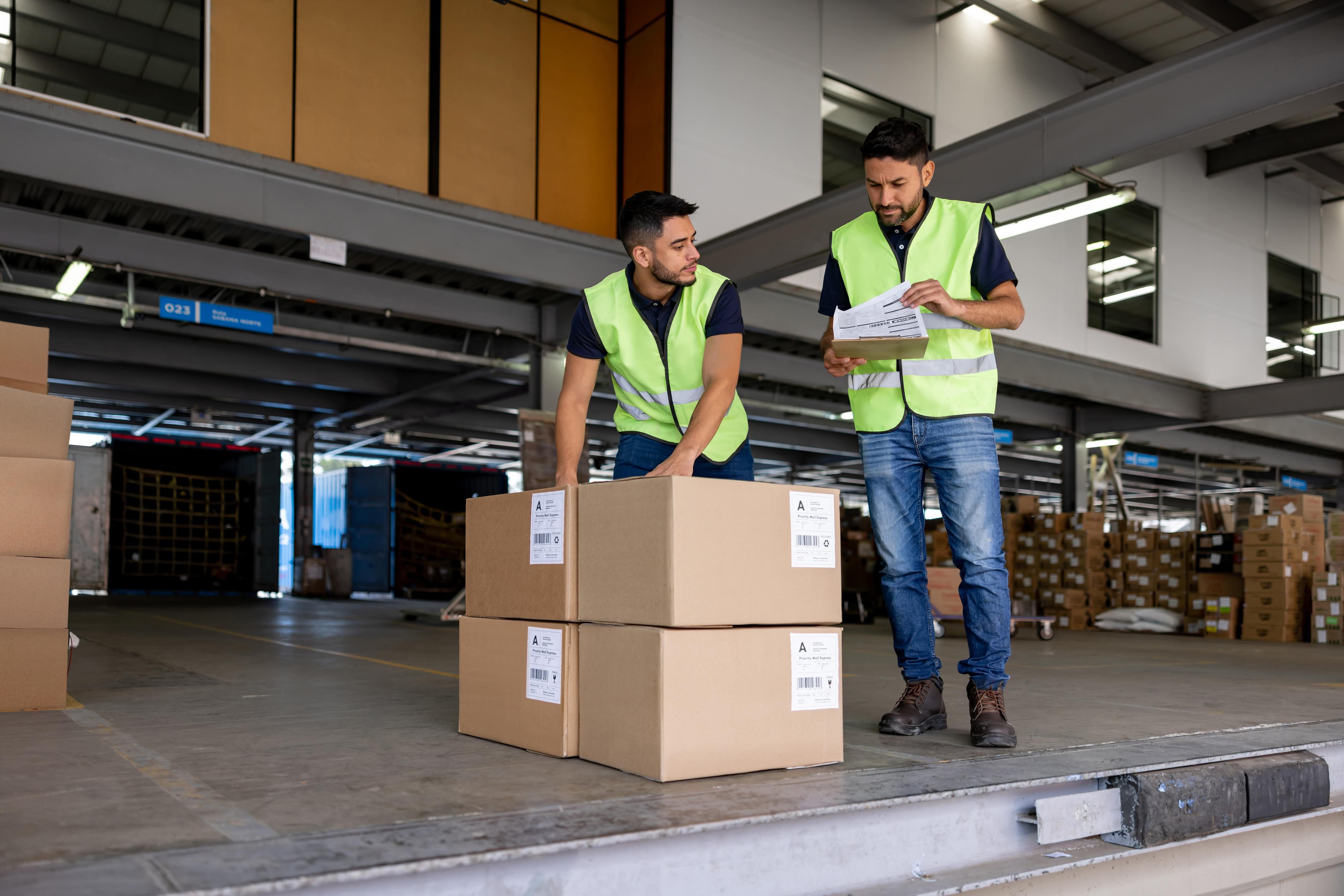 Warehouse workers loading boxes at warehouse dock
