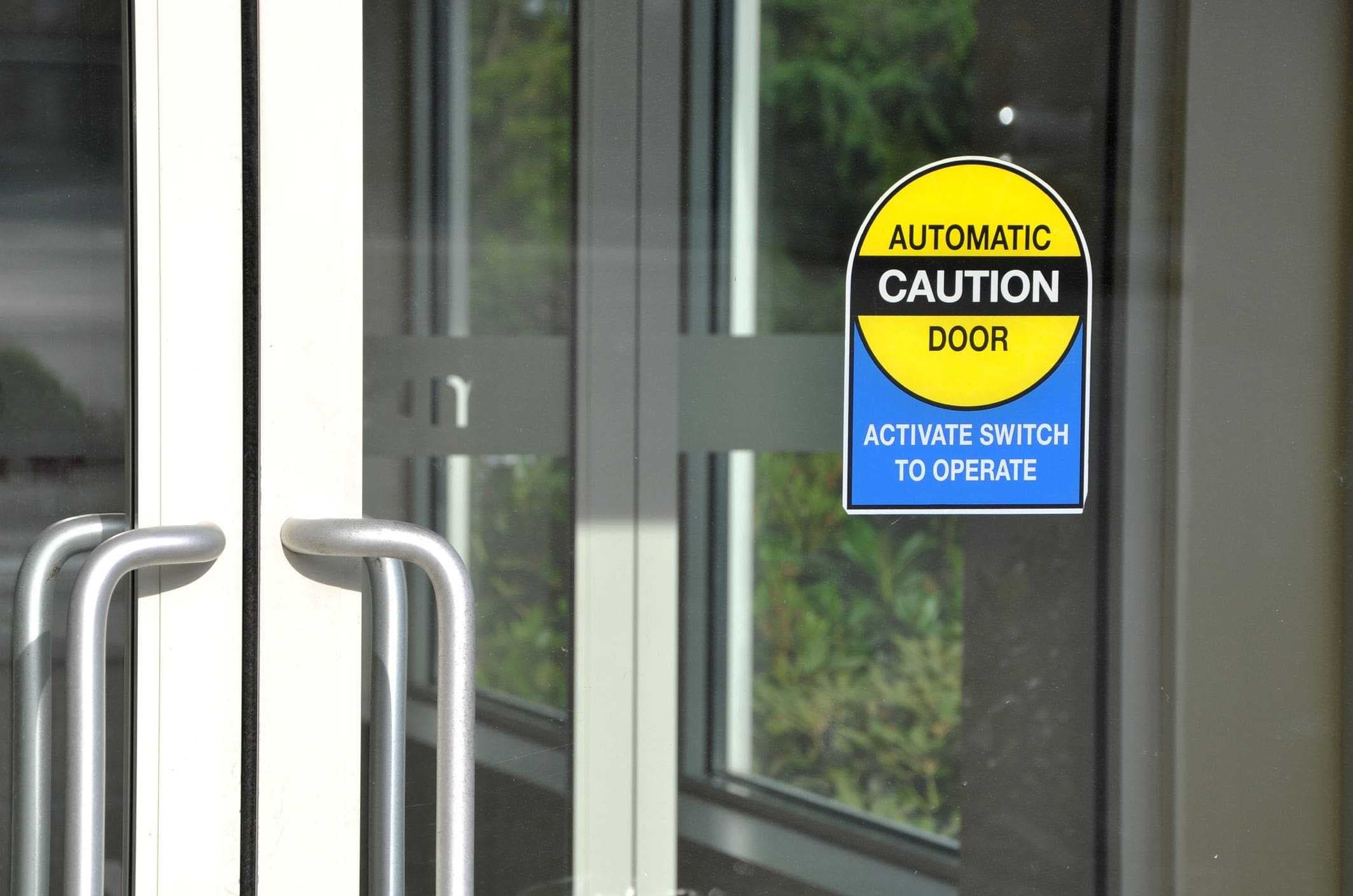 automatic door with caution sign