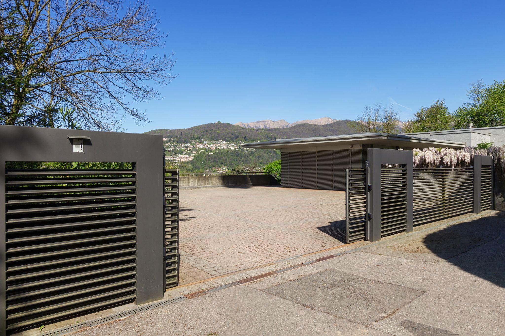 modern black sliding gates with beautiful BC mountains in background