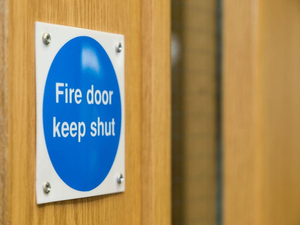 blue fire door sign reads