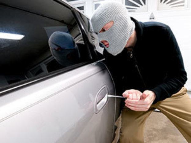Masked man breaking into car Masked man breaking into car