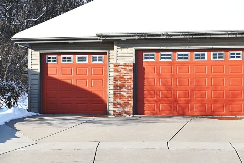 burnt orange garage doors in the winter with insulated glass windows
