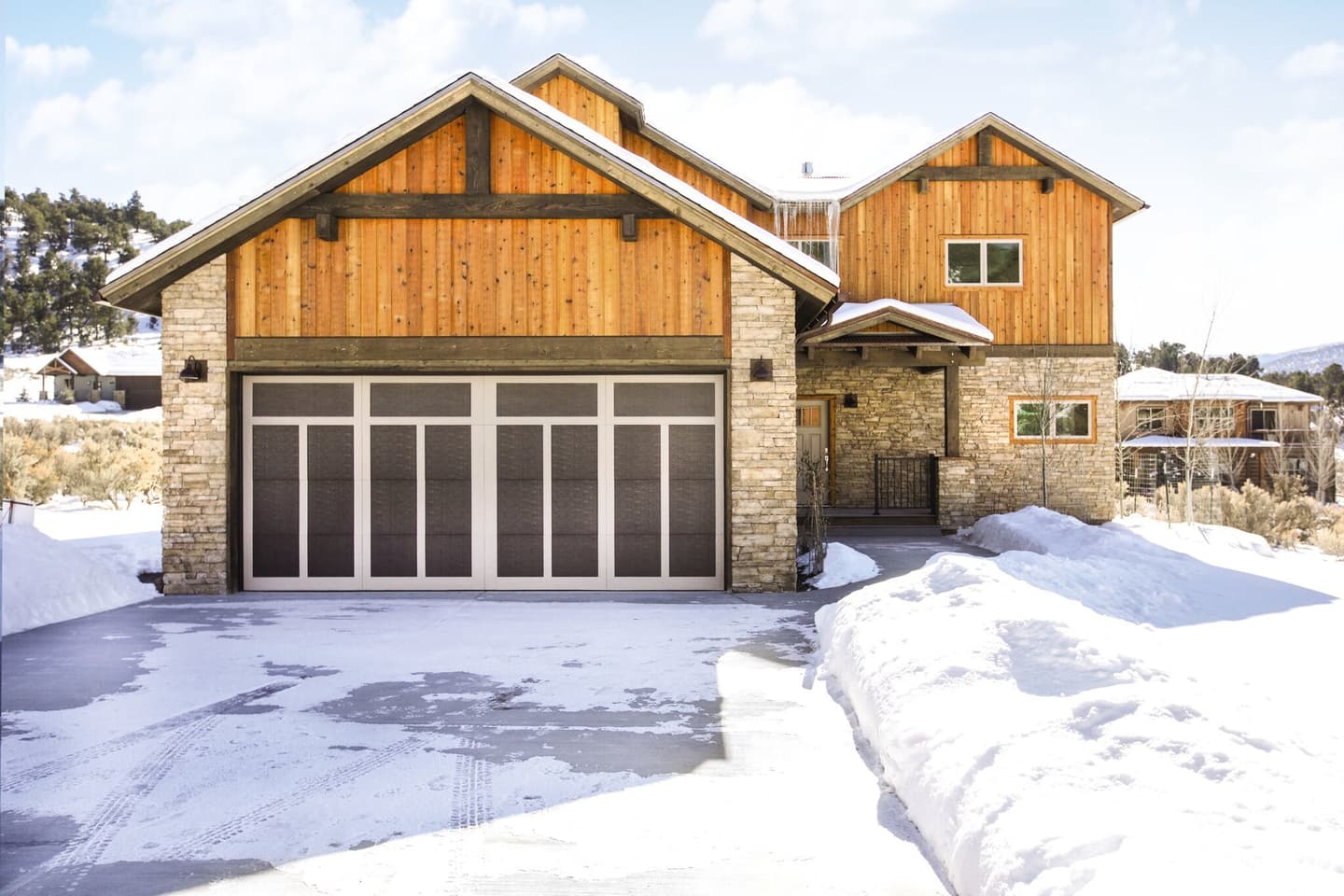 cabin-style-home-with-dark-wood-garage-door-in-the-winter.jpg?mtime=20181123162328#asset:10857:c1440xauto