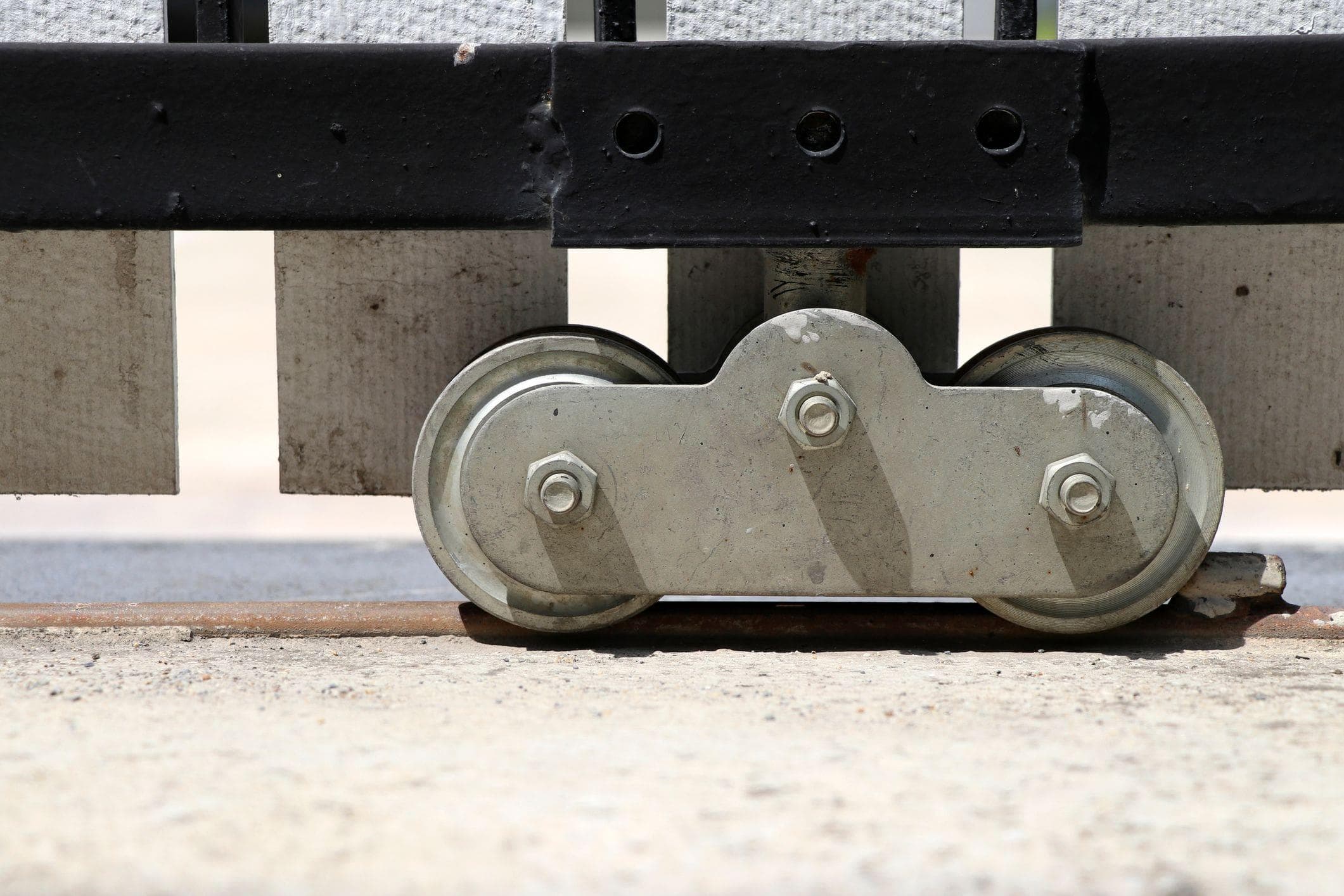 close up of gate tracks and wheel components