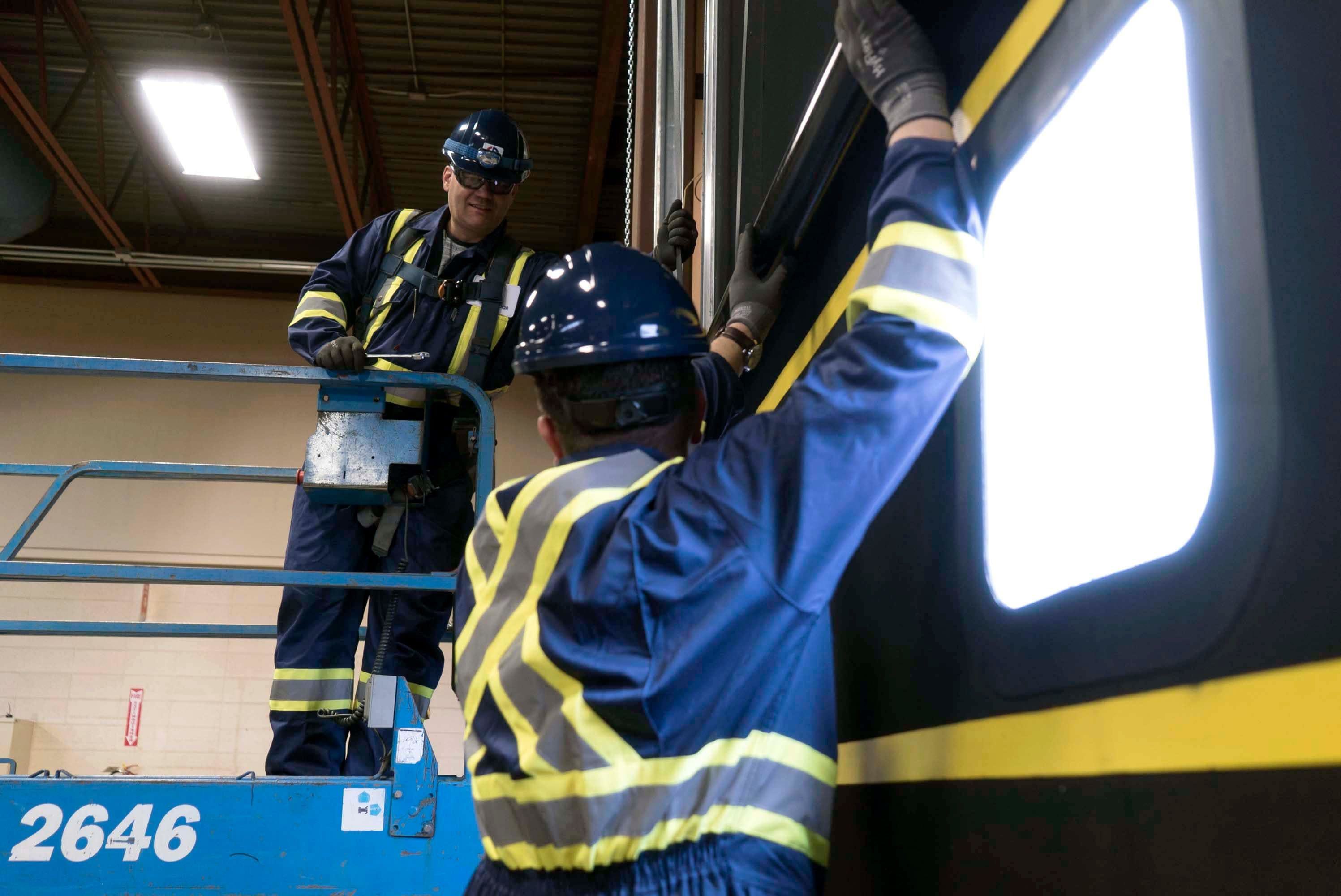 commercial door technicians from CDS working on a sectional door in Vancouver