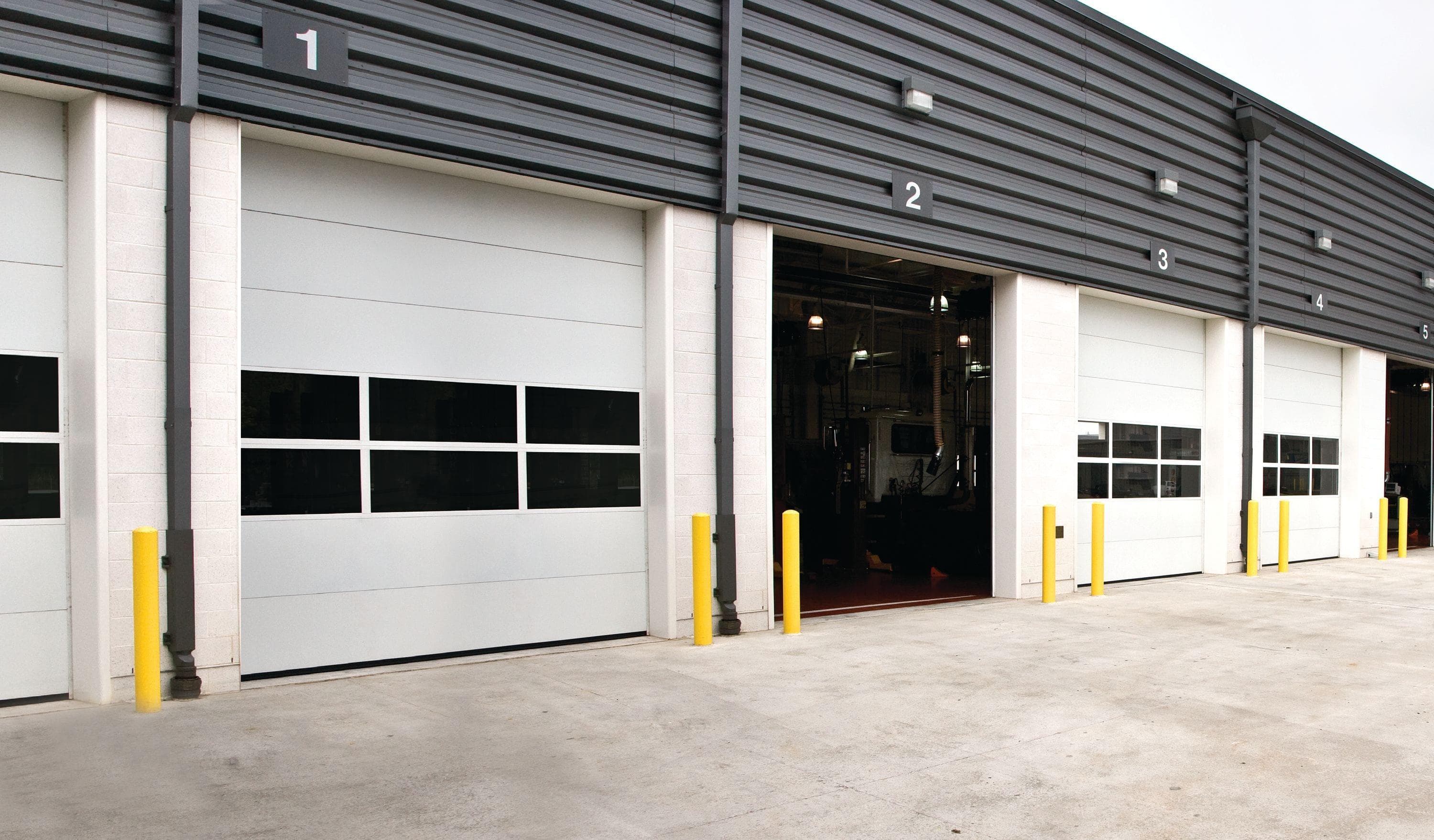 exterior of commercial building with row of overhead doors
