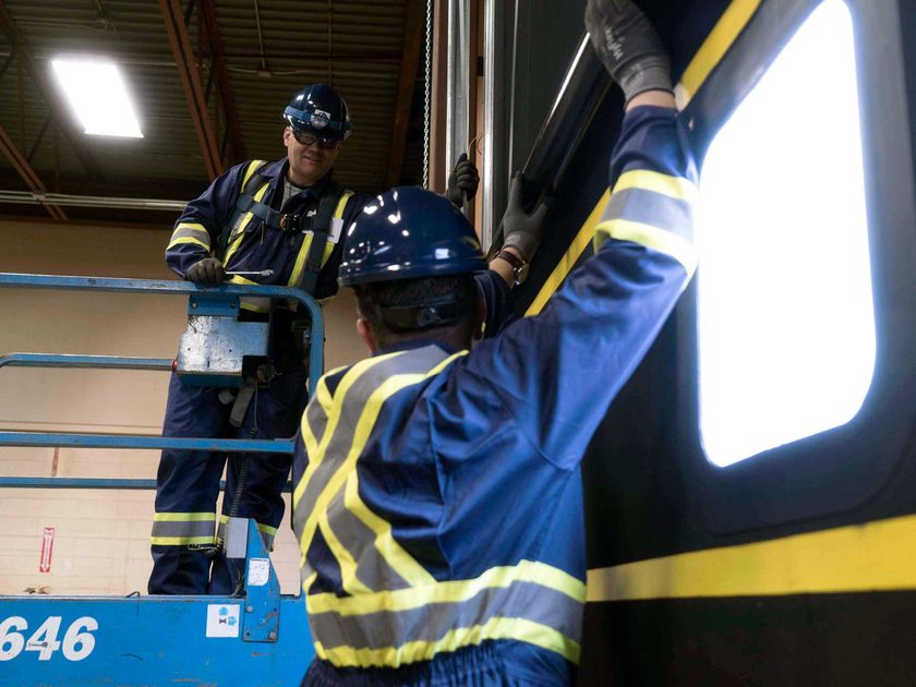 Creative Door Services technicians repairing commercial door