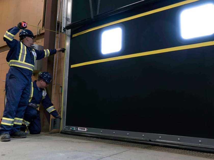 Creative Door Services technicians inspecting commercial high performance door