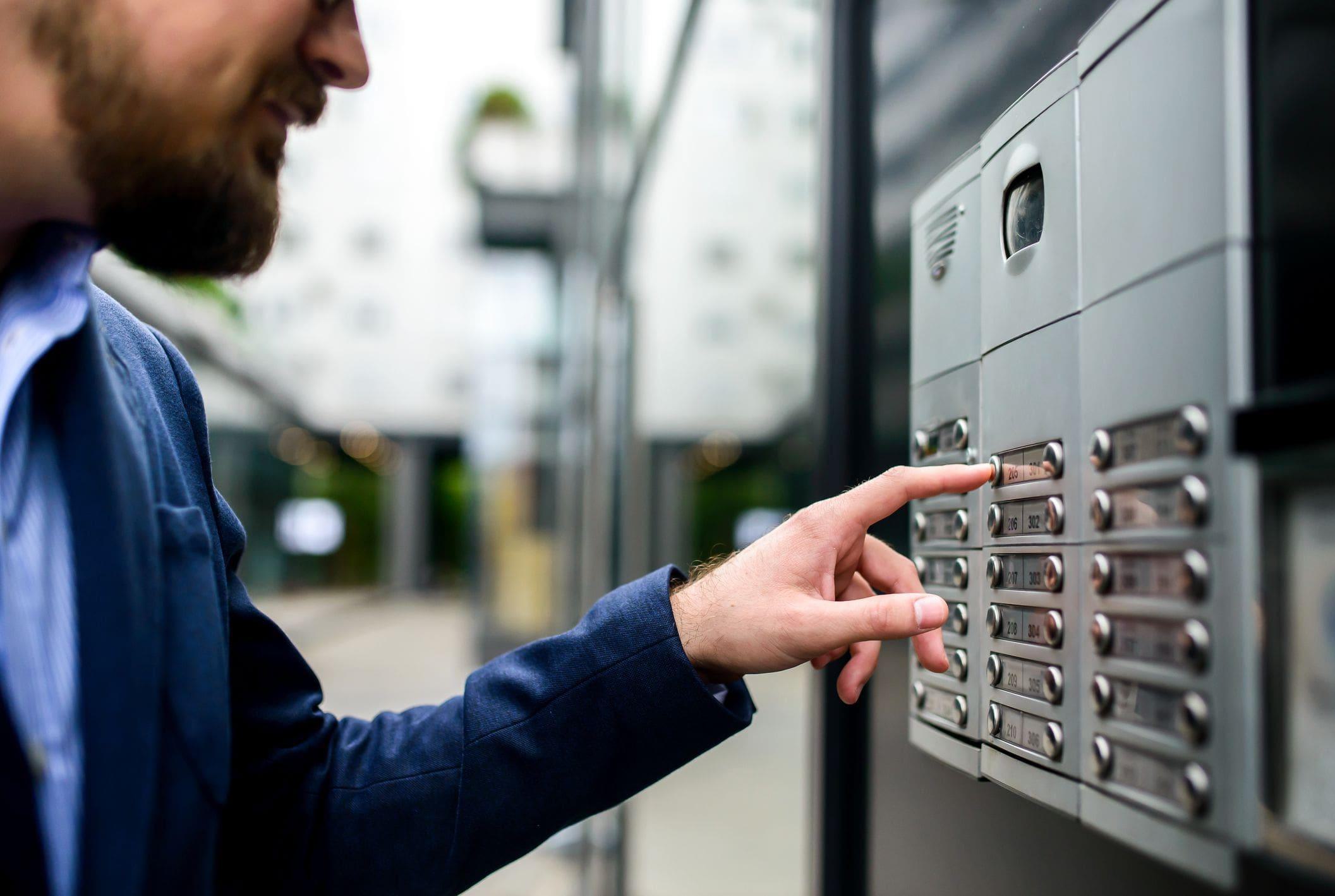 man using telecom system to enter apartment man using telecom system to enter apartment
