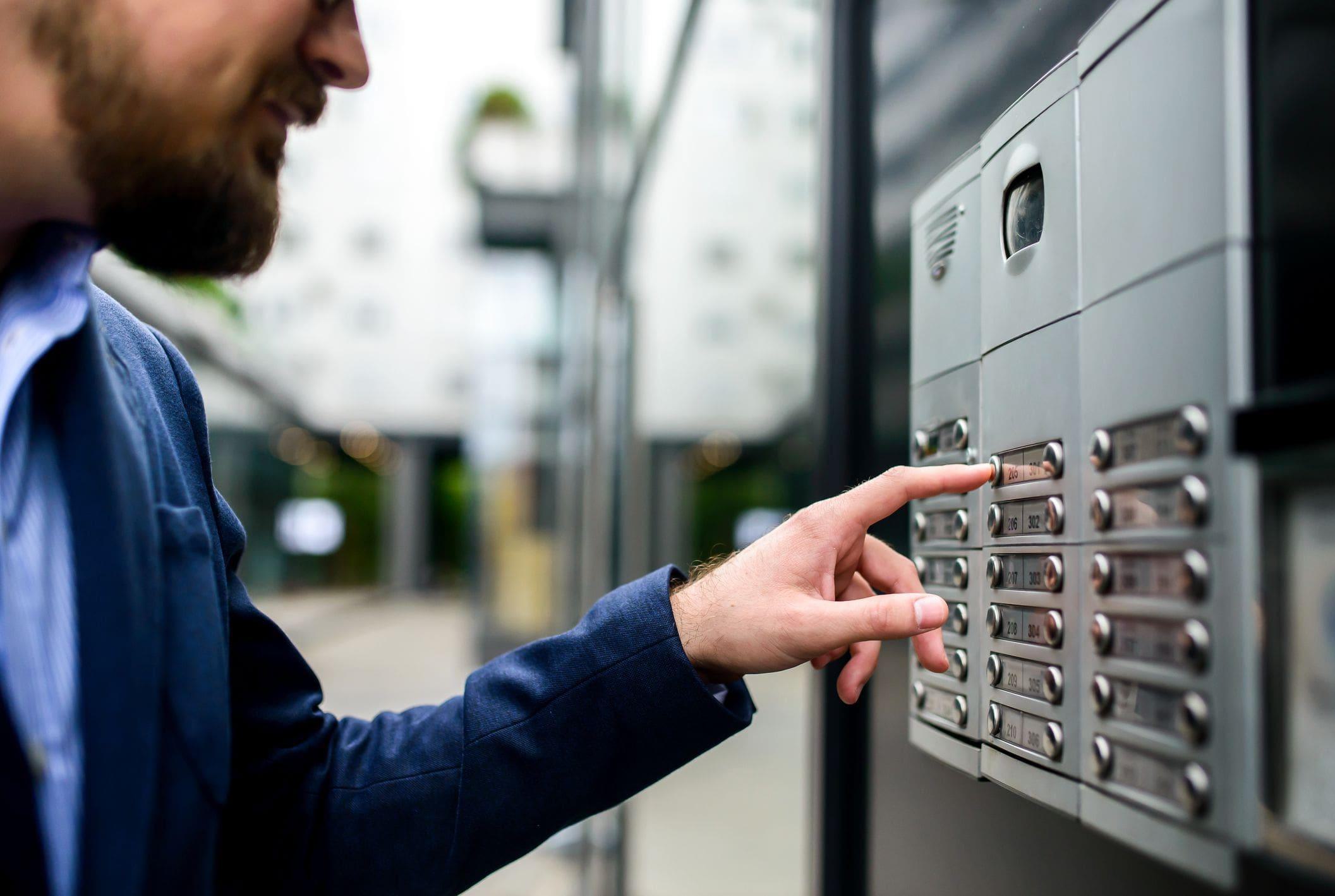 man using telecom system to enter apartment