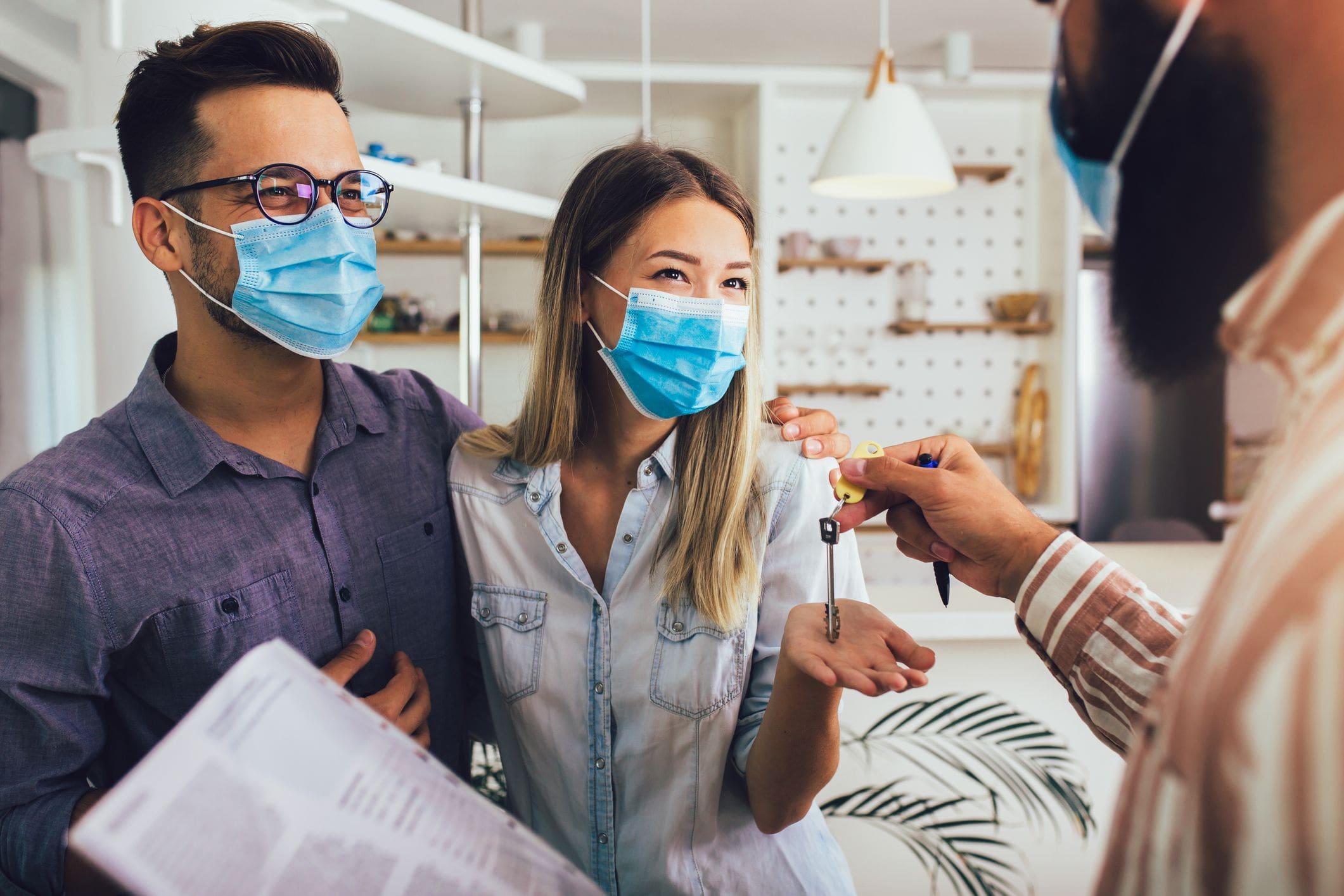couple wearing masks meeting with company couple wearing masks meeting with company