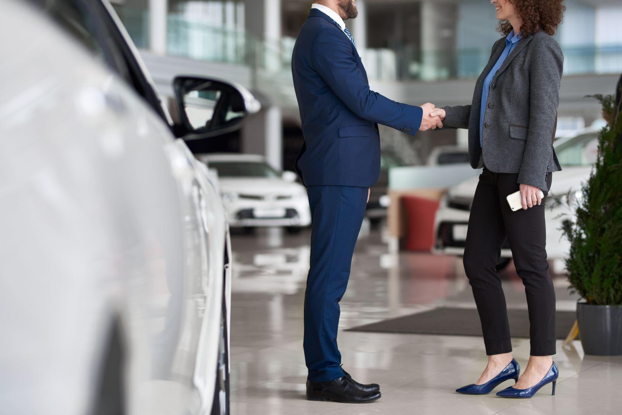 interior of car dealership showroom with large glass windows in background interior of car dealership showroom with large glass windows in background