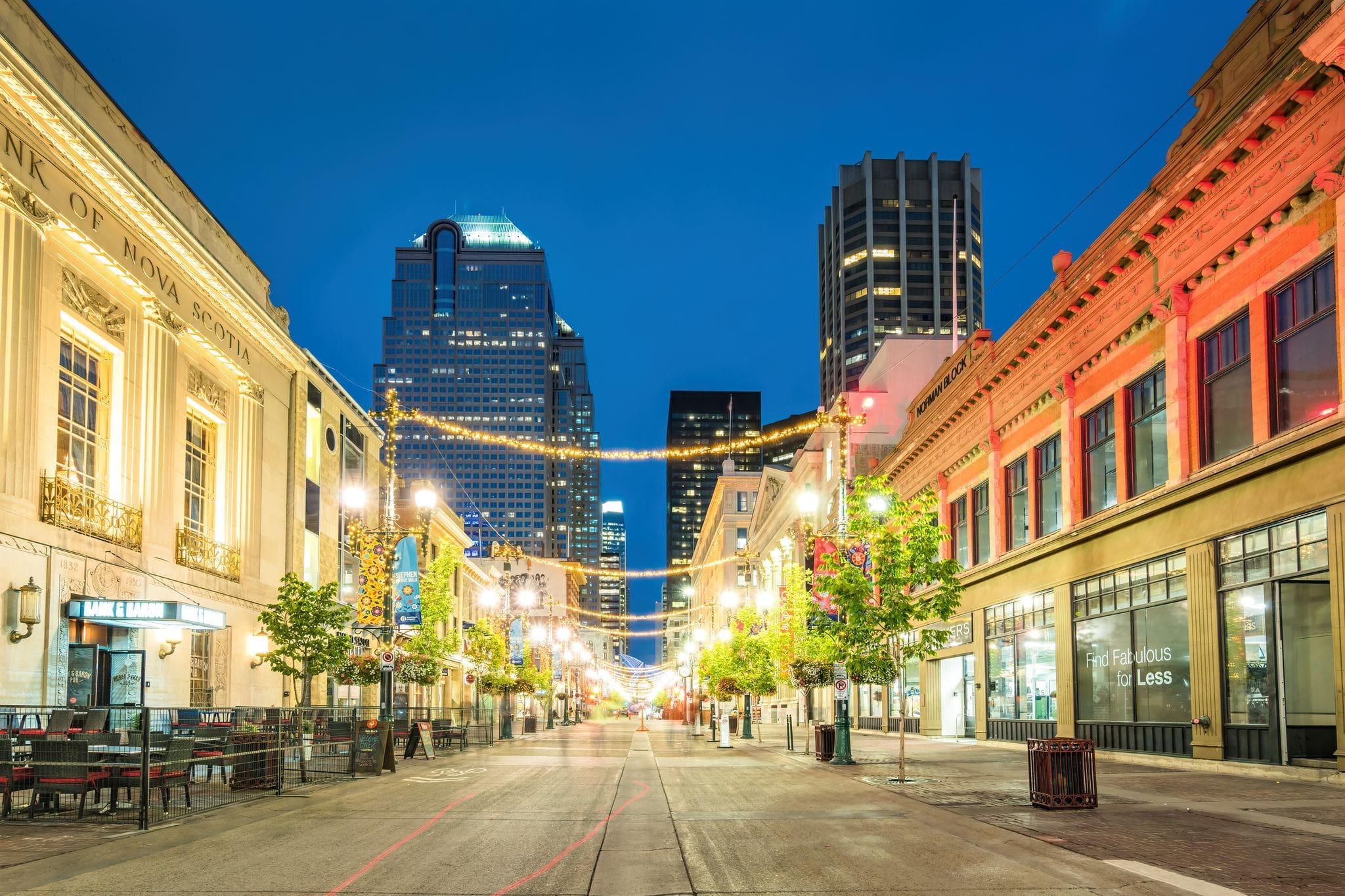 a well-lit road lined with storefronts a well-lit road lined with storefronts