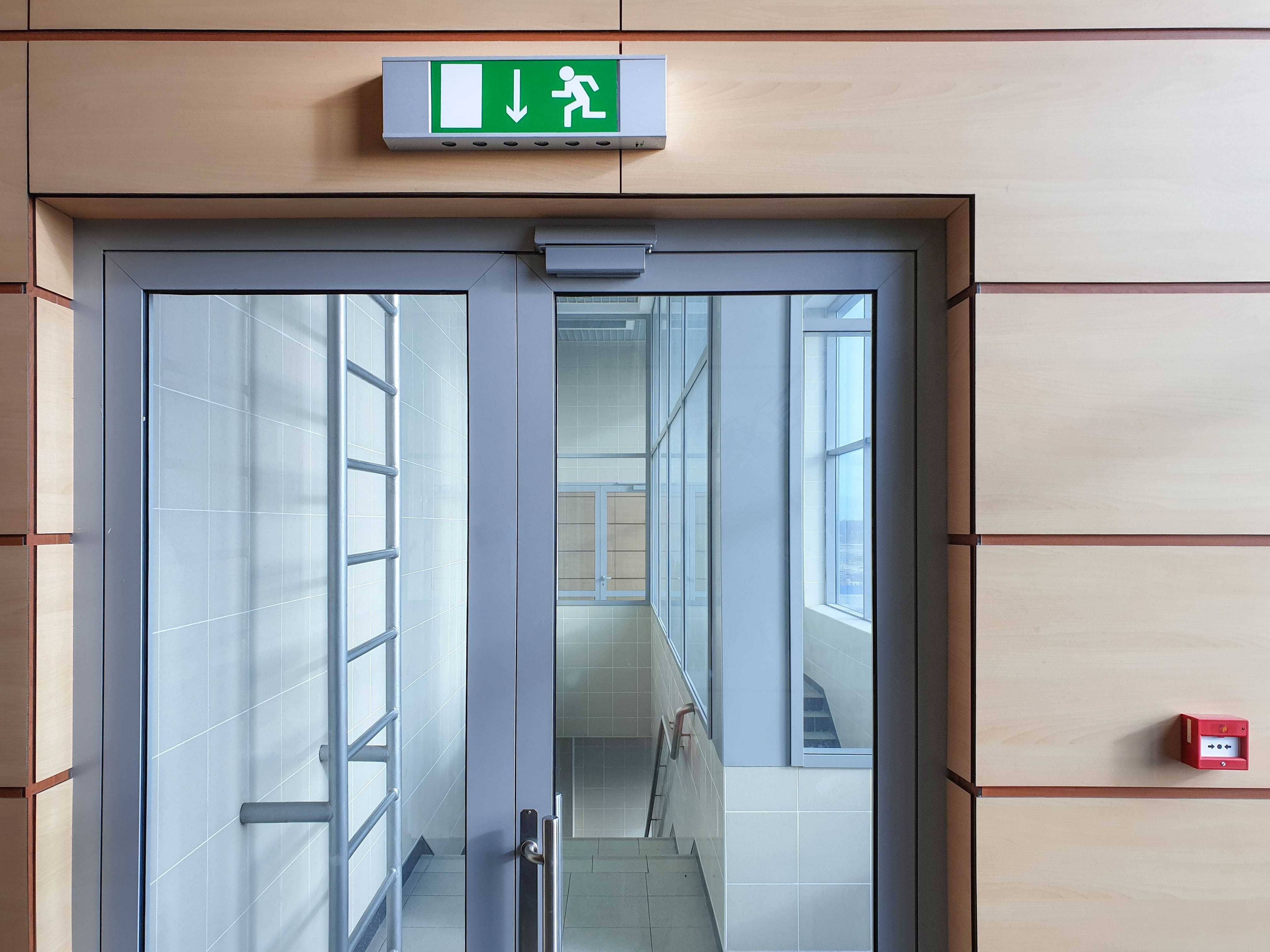 glass doors for emergency fire exit in office hallway