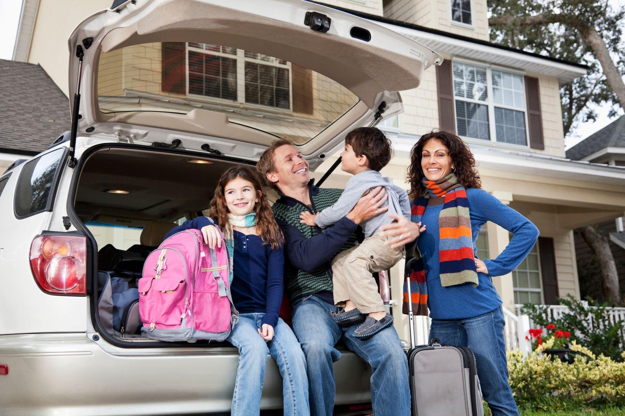 family preparing car for a road trip