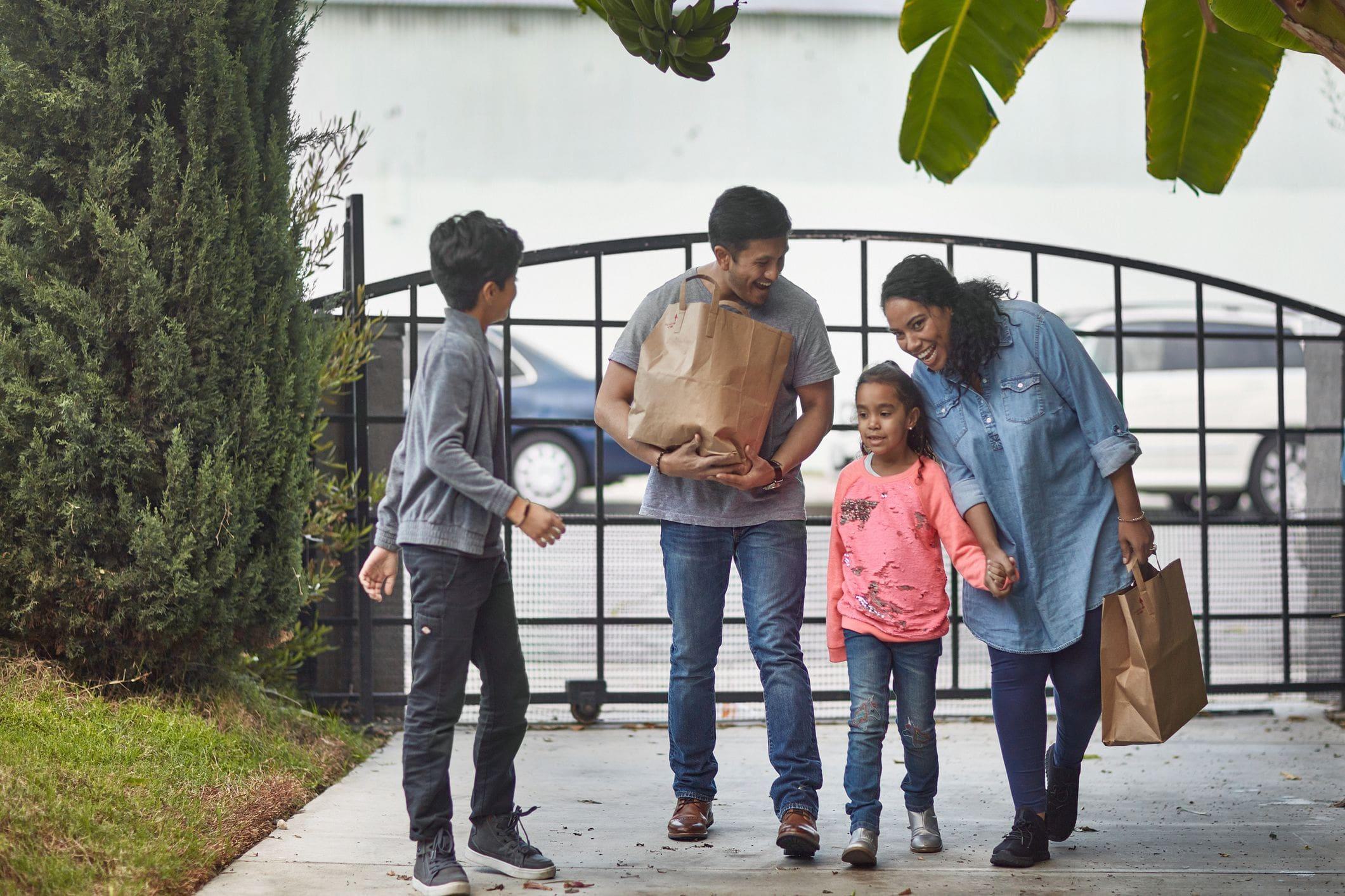 a family returning home from shopping using their gate a family returning home from shopping using their gate