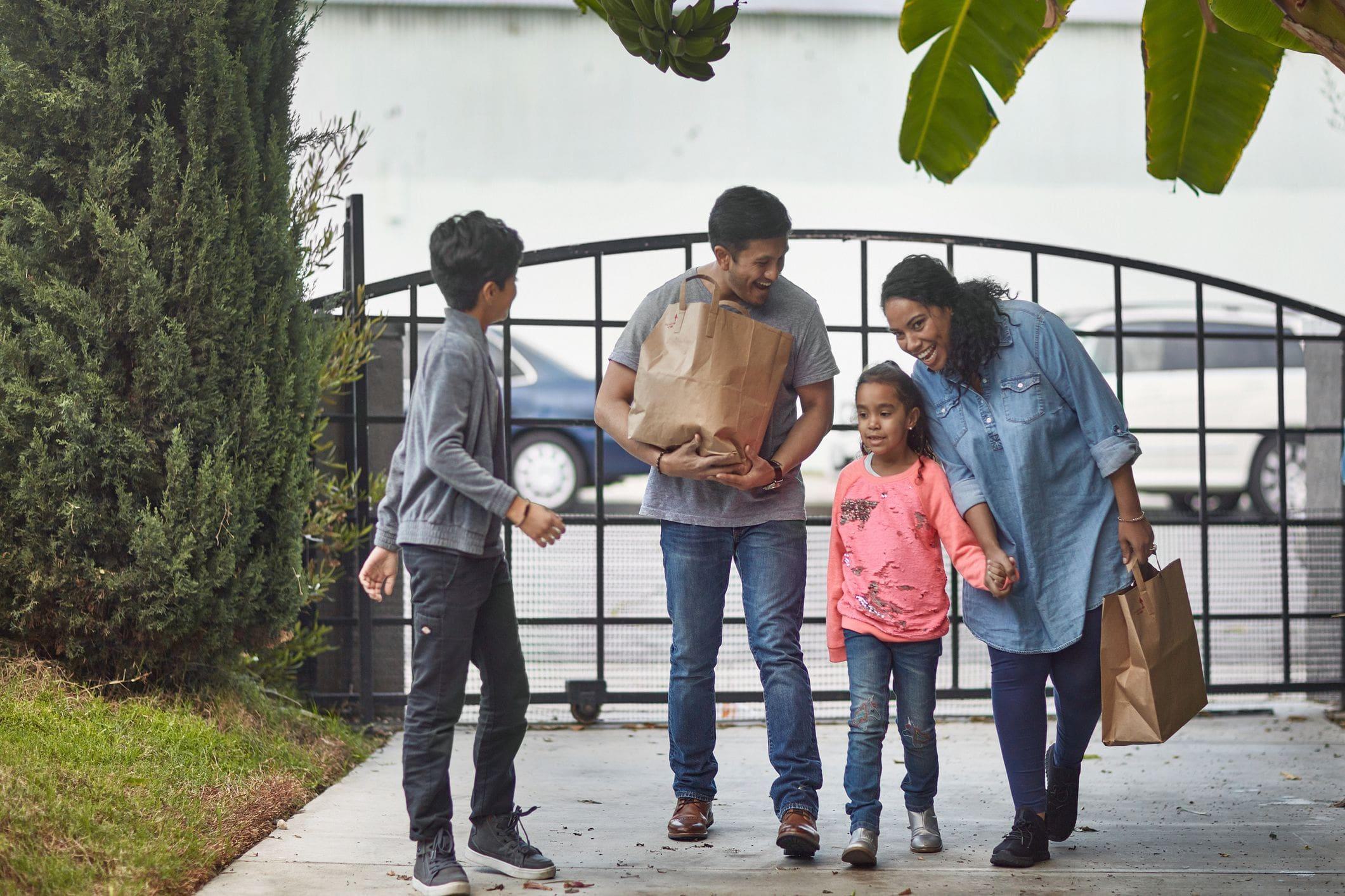 a family returning home from shopping using their gate 