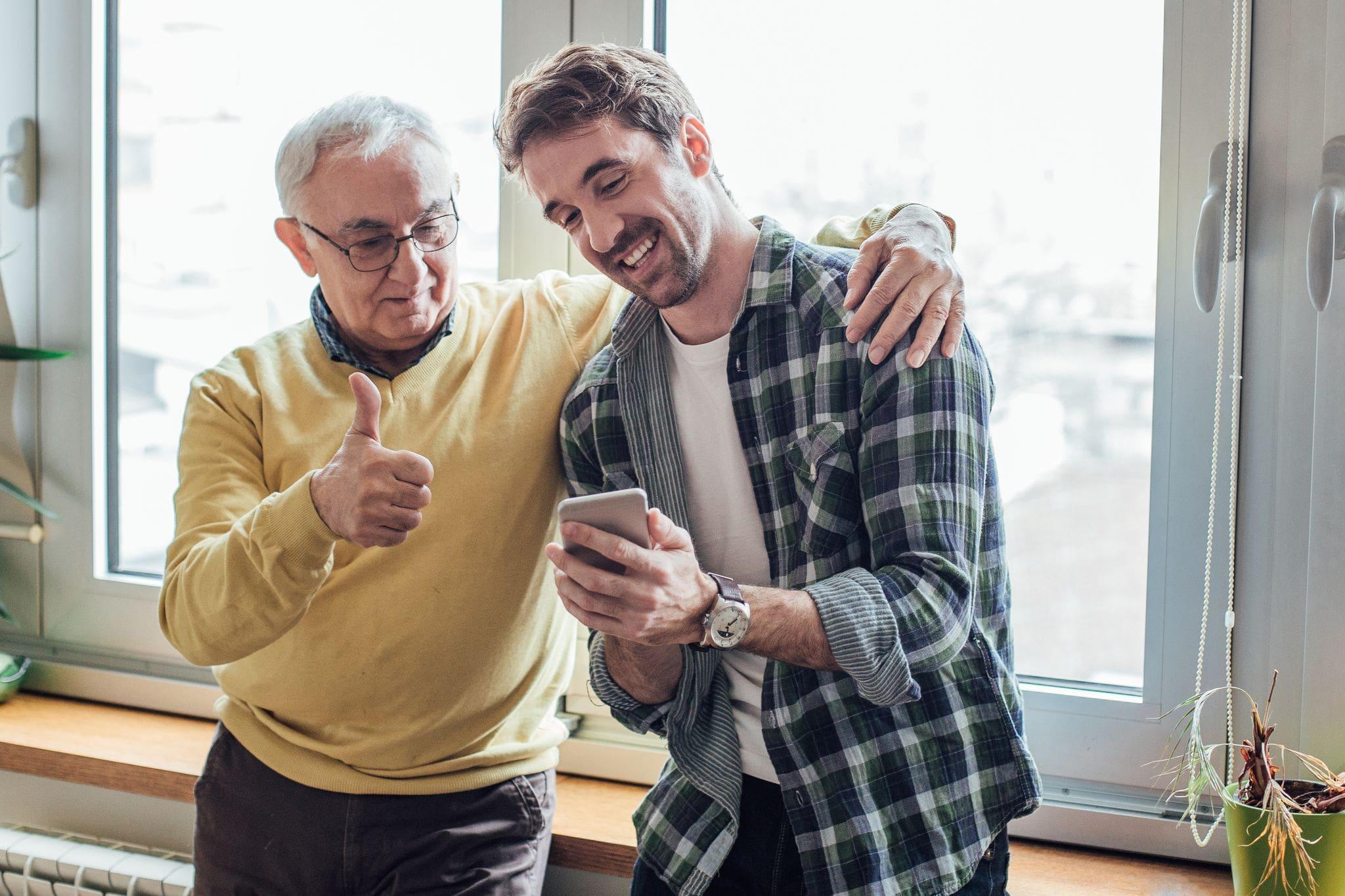 father and son thumbs up multigenerational father and son thumbs up multigenerational