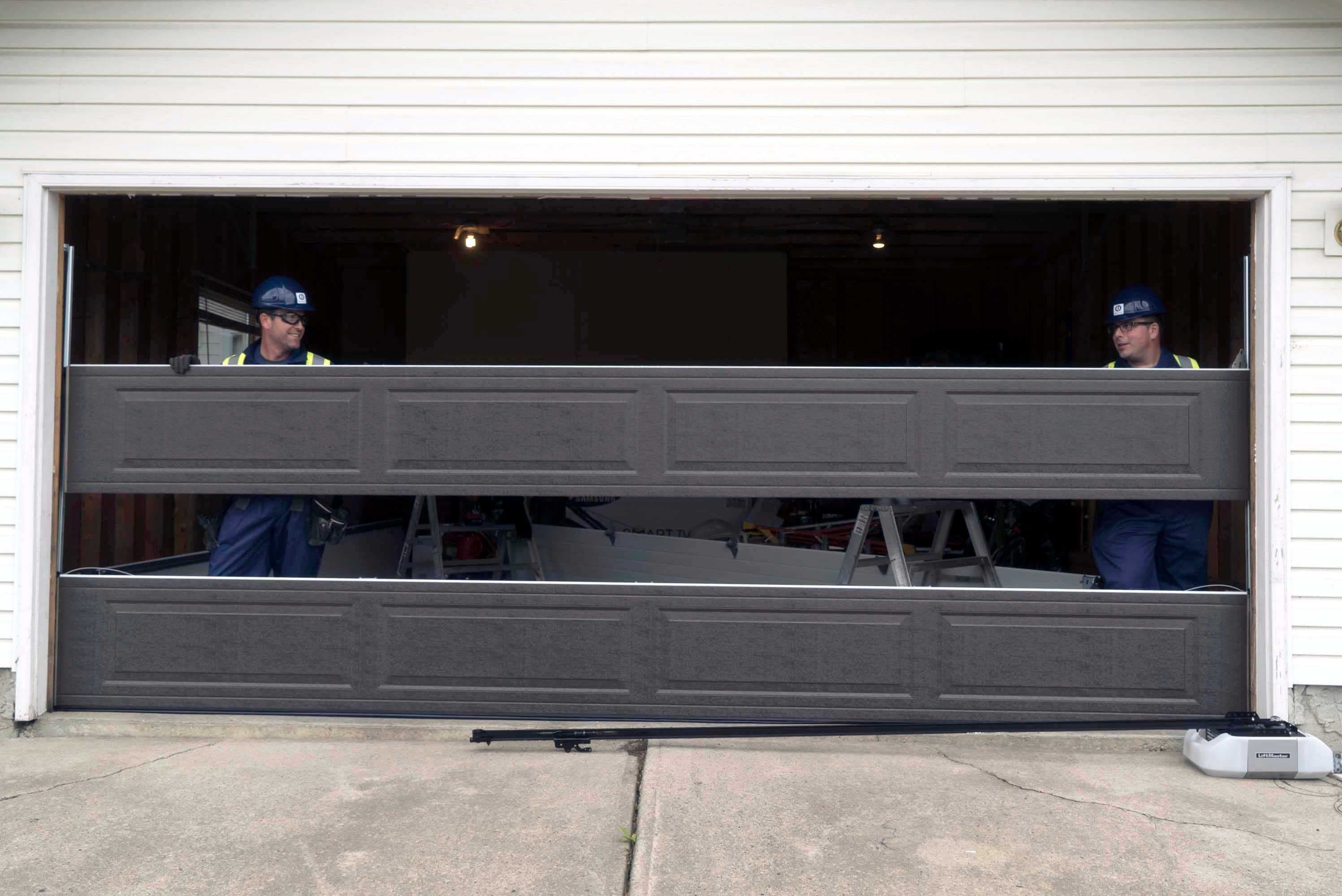 two technicians installing a wayne dalton garage door