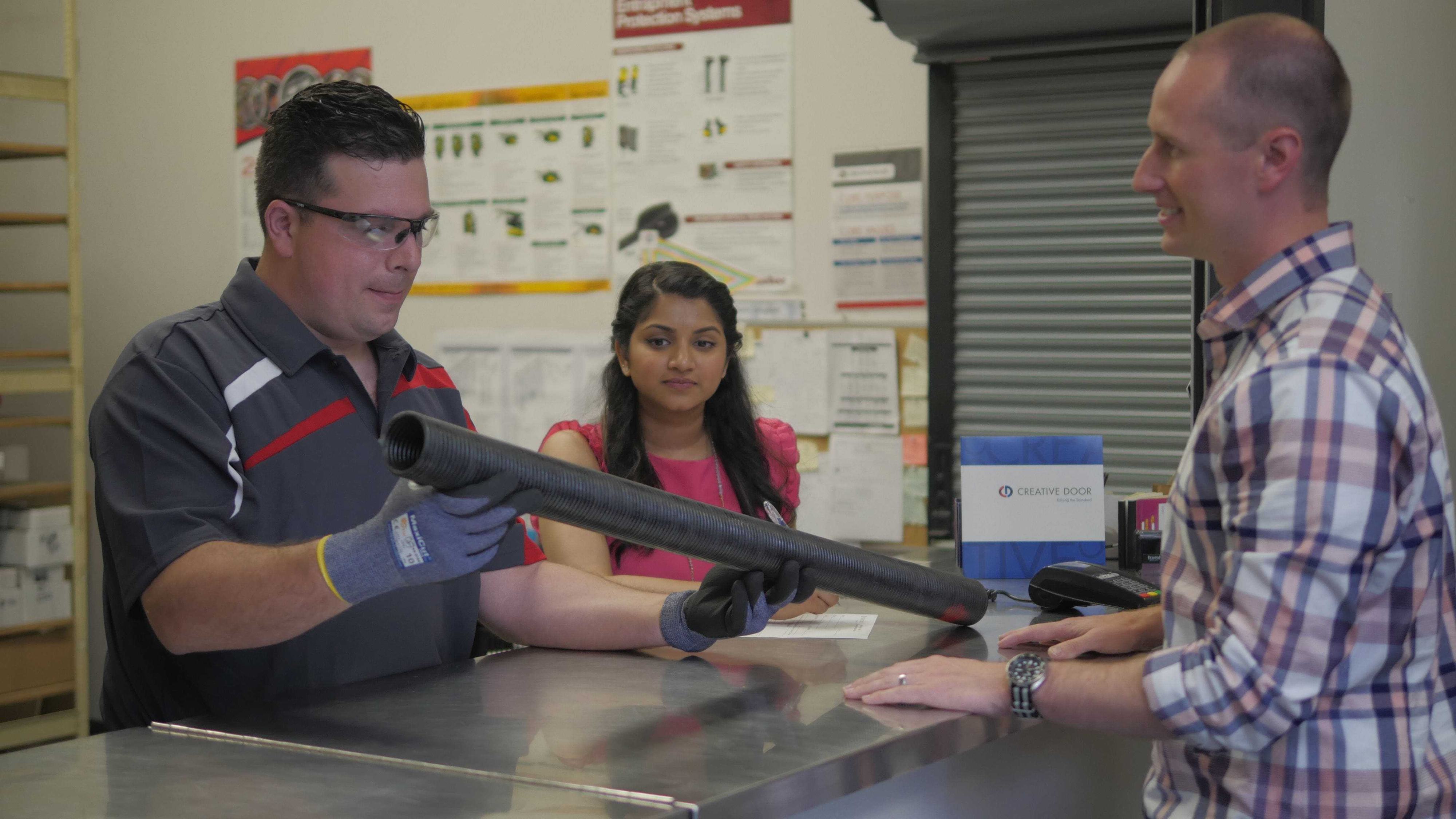 selecting a brand new garage door spring from creative door's showroom selecting a brand new garage door spring from creative door's showroom