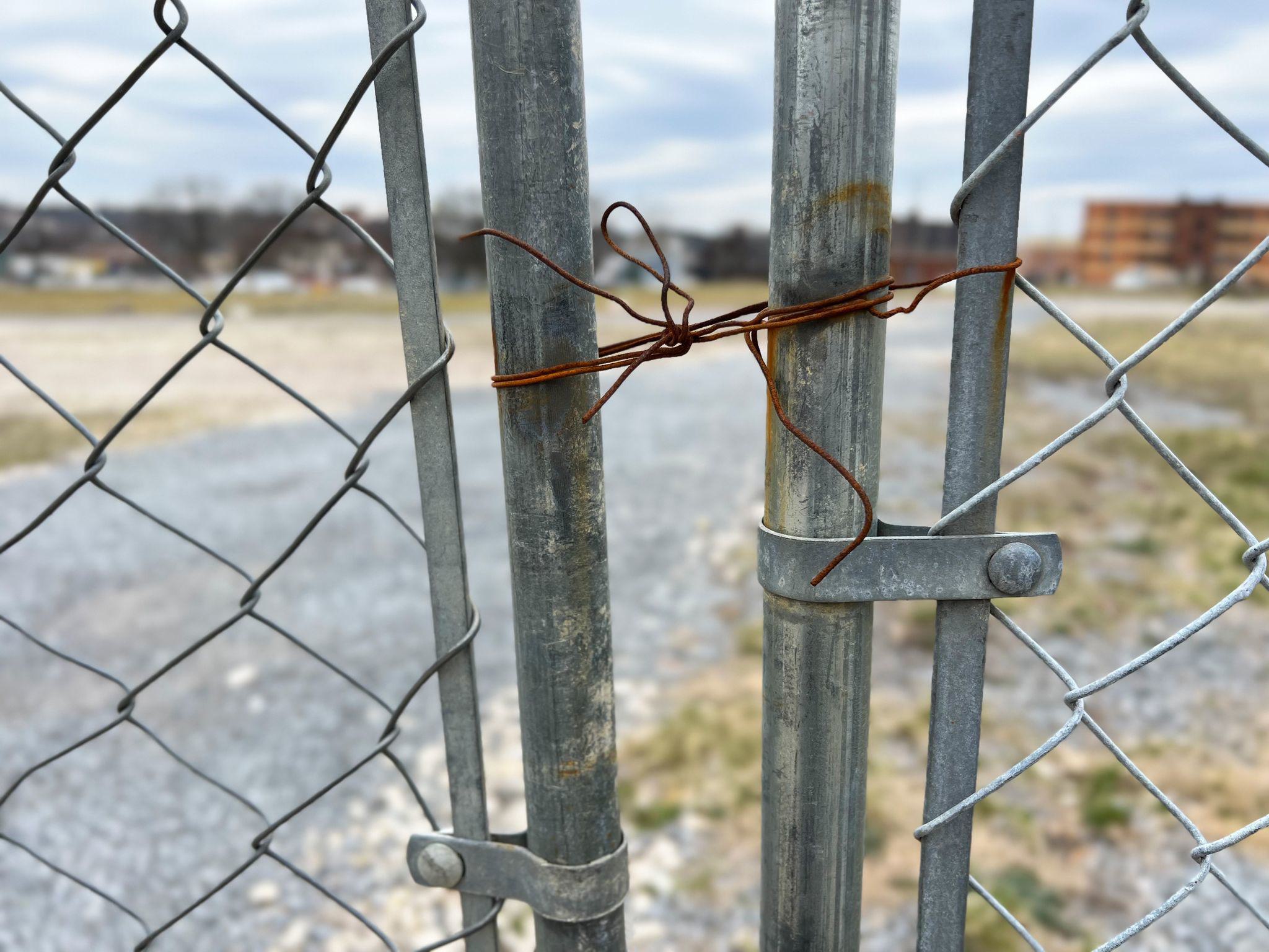 gate being held closed with a rusty old wire