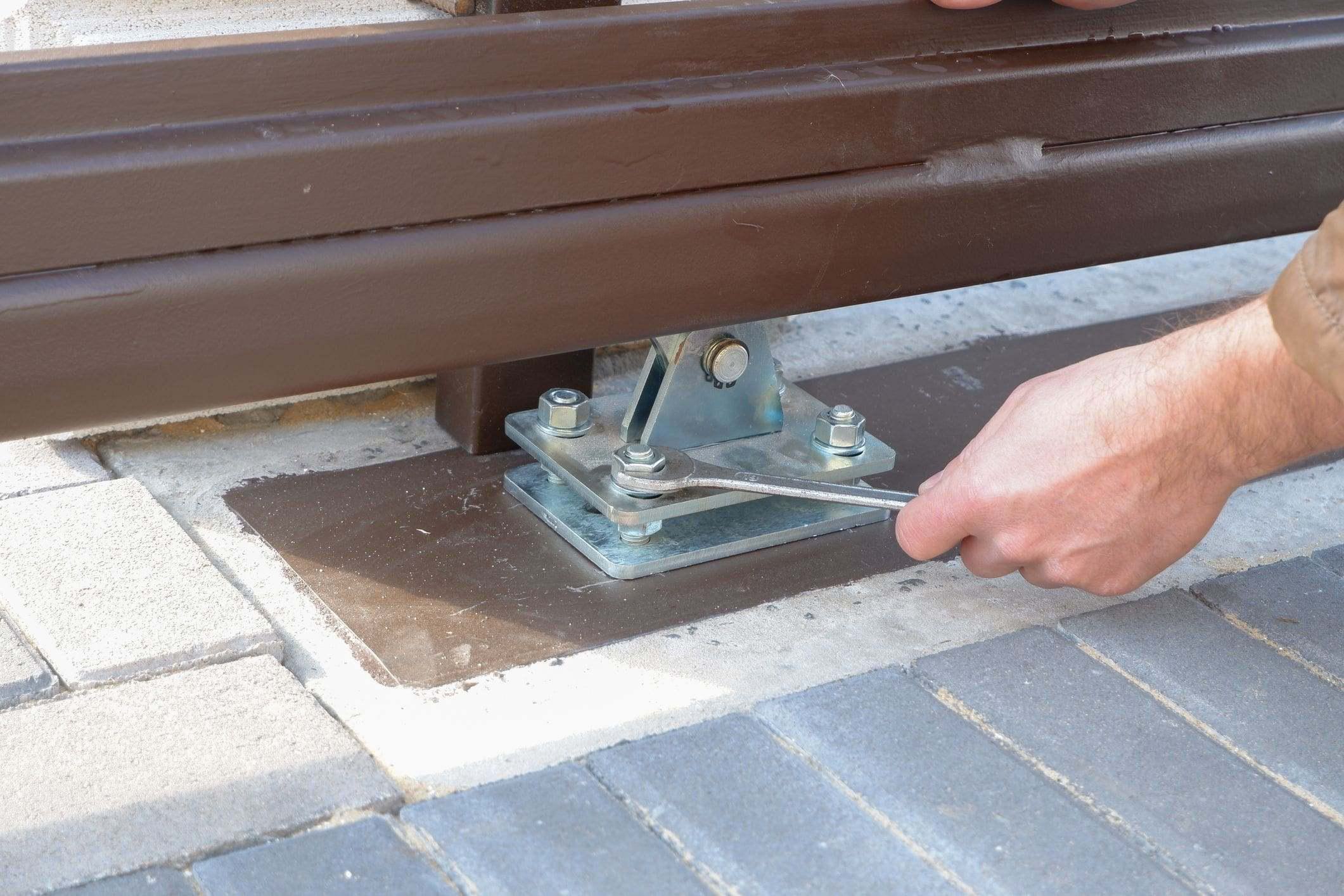 technician tightening hardware for gate tracks technician tightening hardware for gate tracks