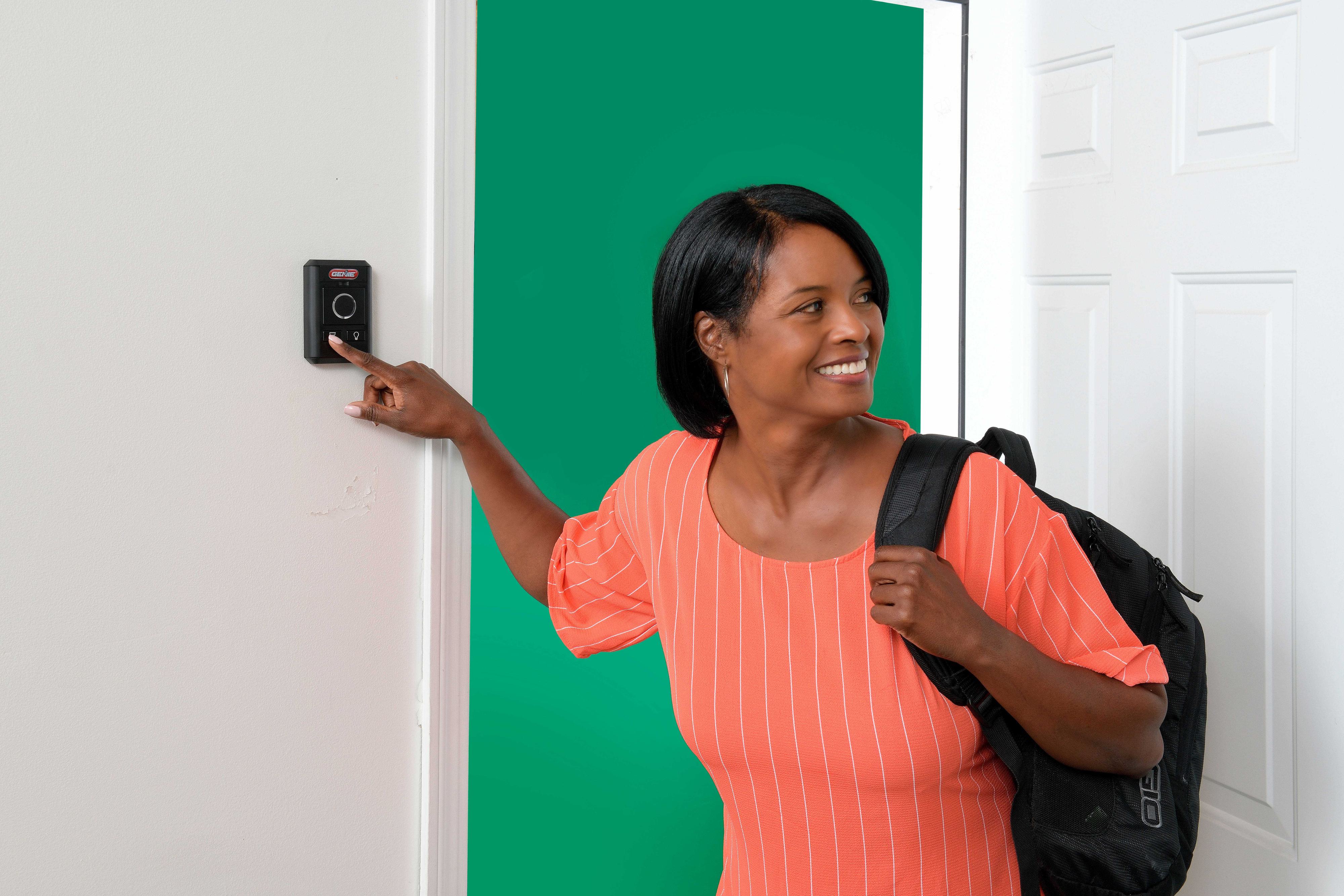 woman in pink shirt pressing the genie wall console woman in pink shirt pressing the genie wall console