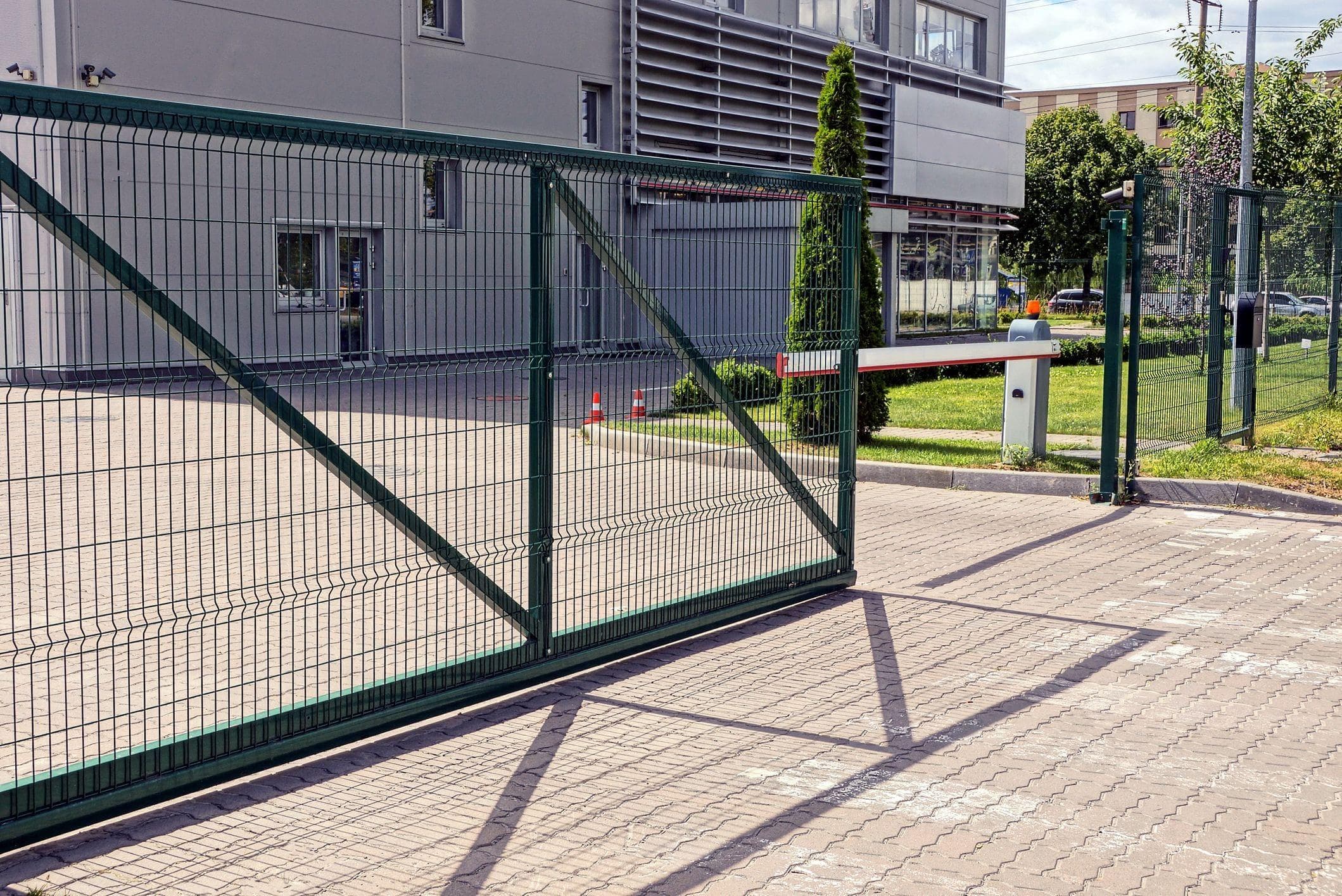 green metal slide gate for commercial property entrance