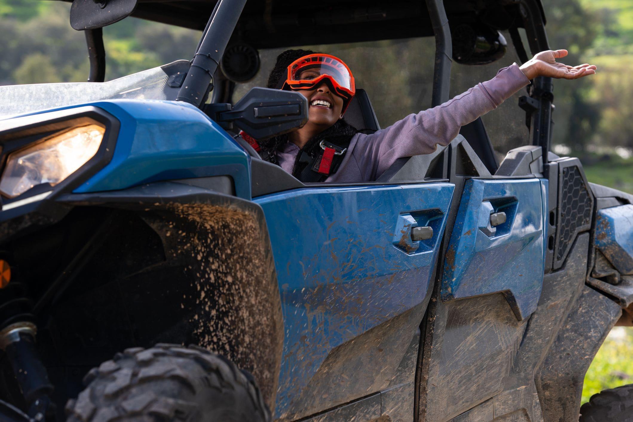 happy woman off roading in ATV 