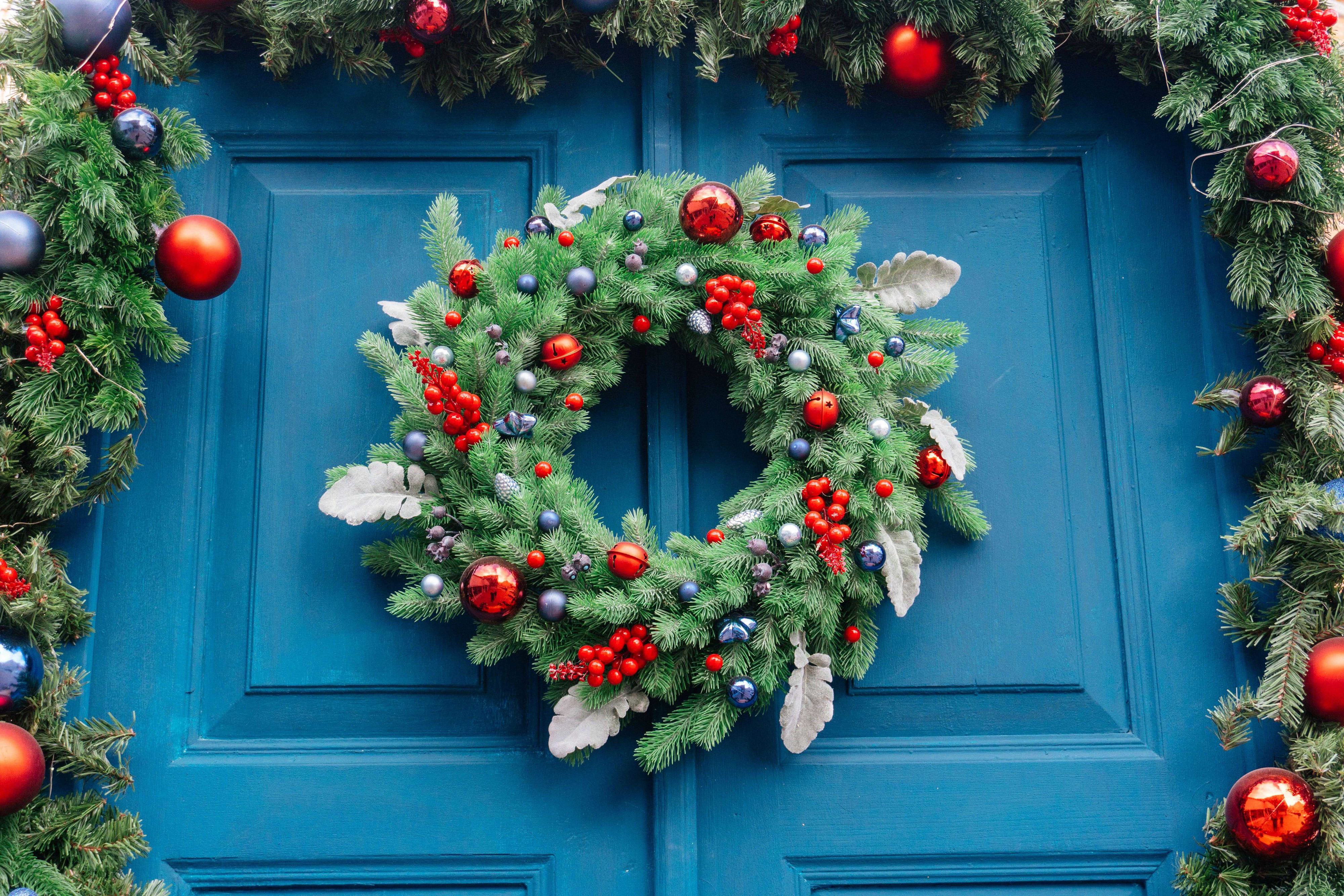 perfect holiday wreath and garland on a blue door perfect holiday wreath and garland on a blue door
