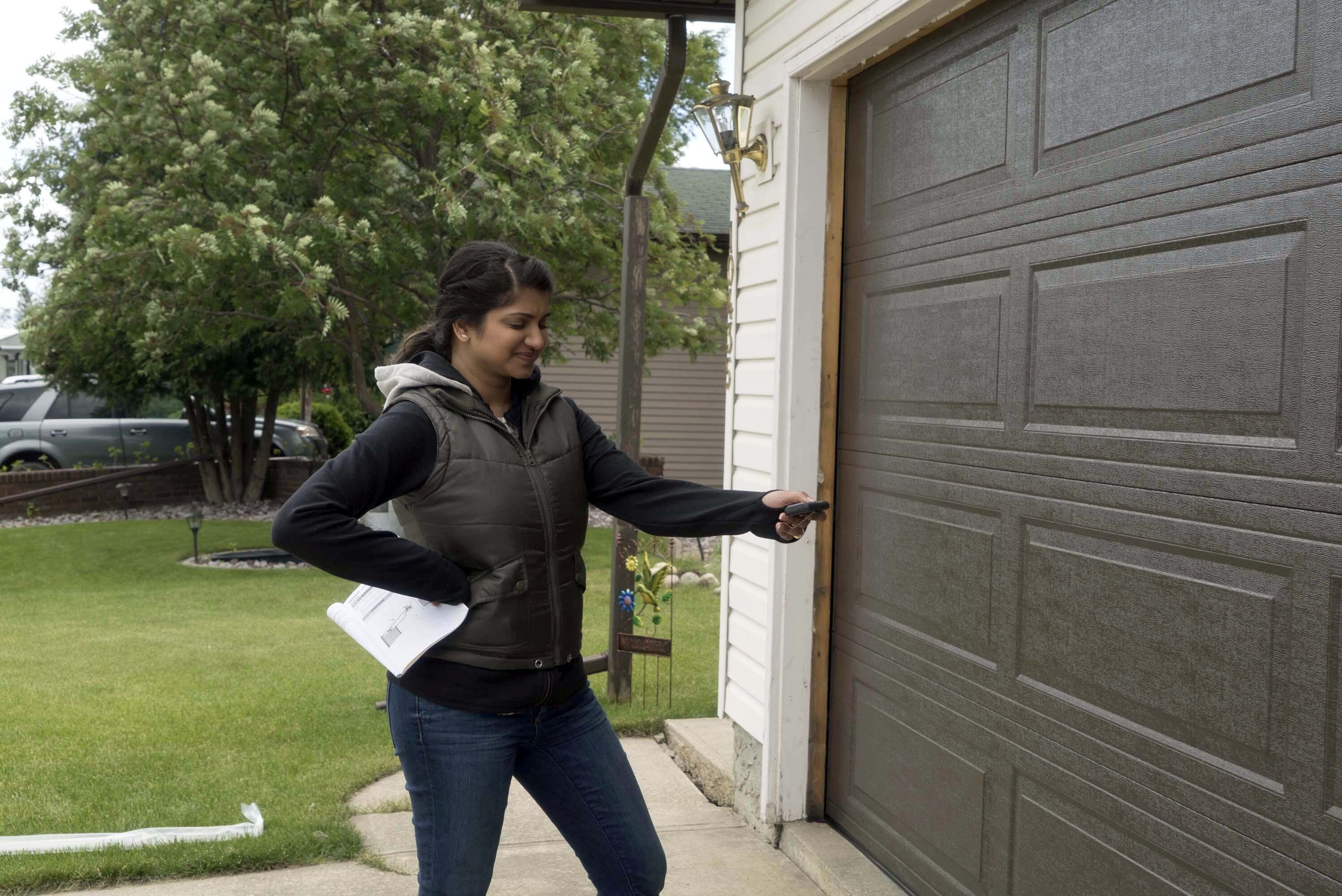 homeowner using garage door remote control