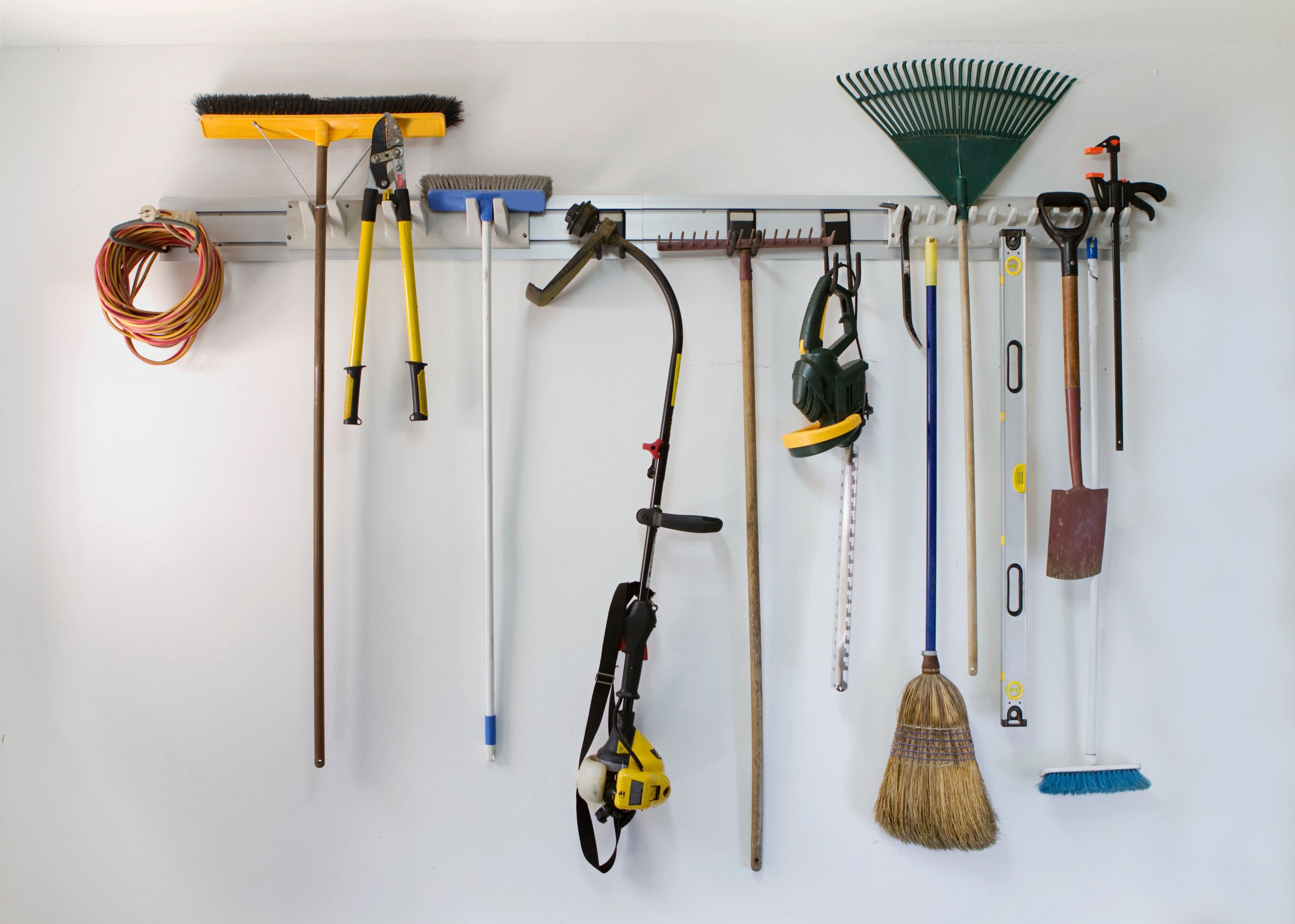 hooks to organize lawn care items inside a garage