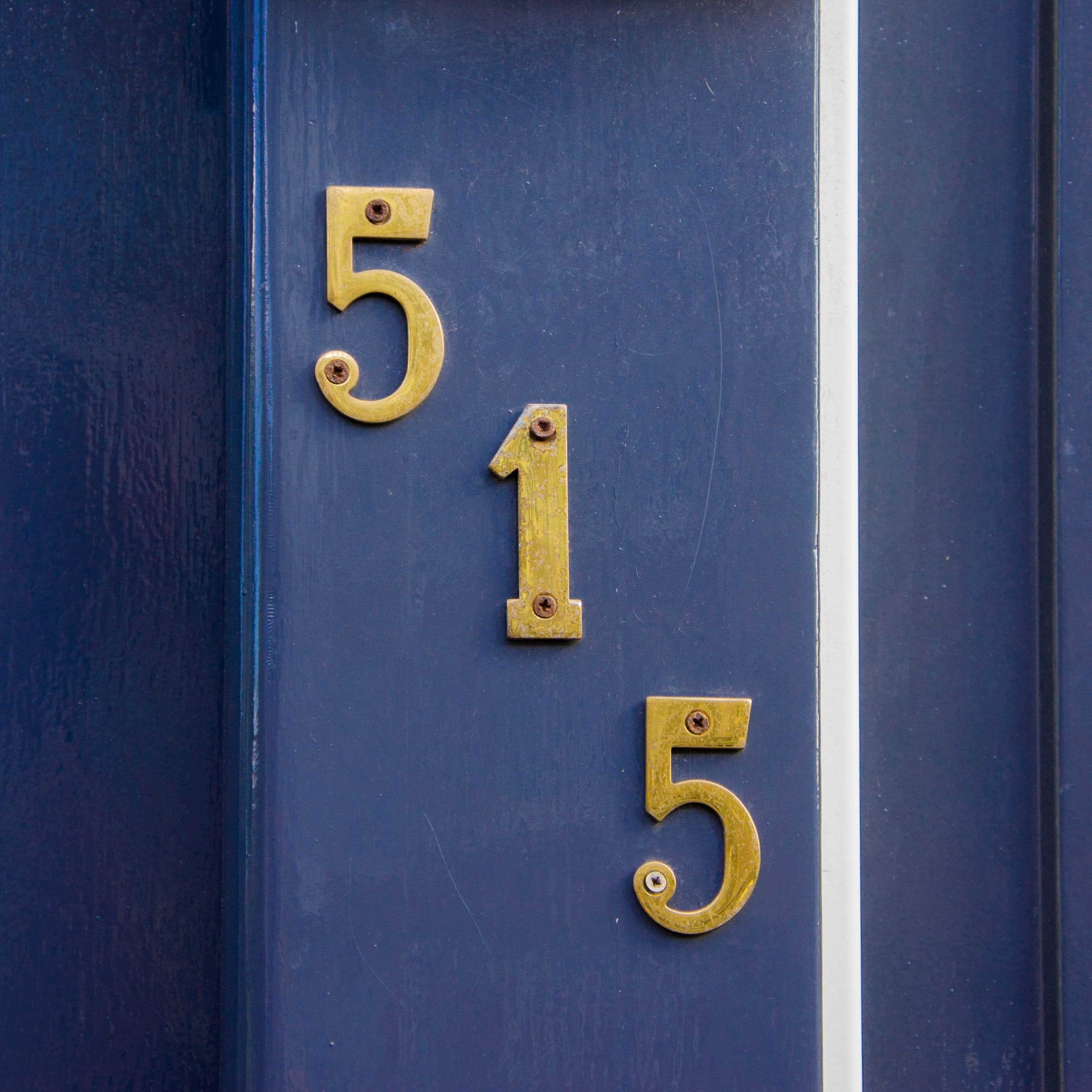 house number displayed on navy blue door trim