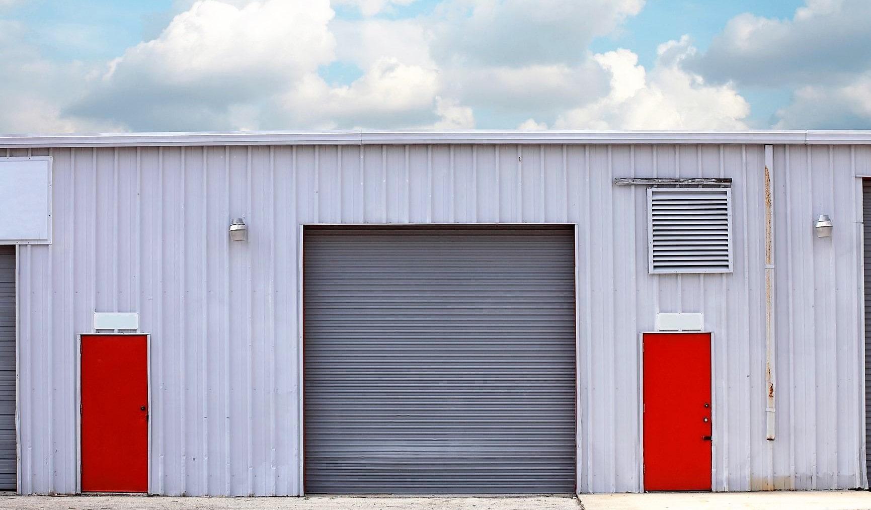 industrial warehouse with red pedestrian doors industrial warehouse with red pedestrian doors