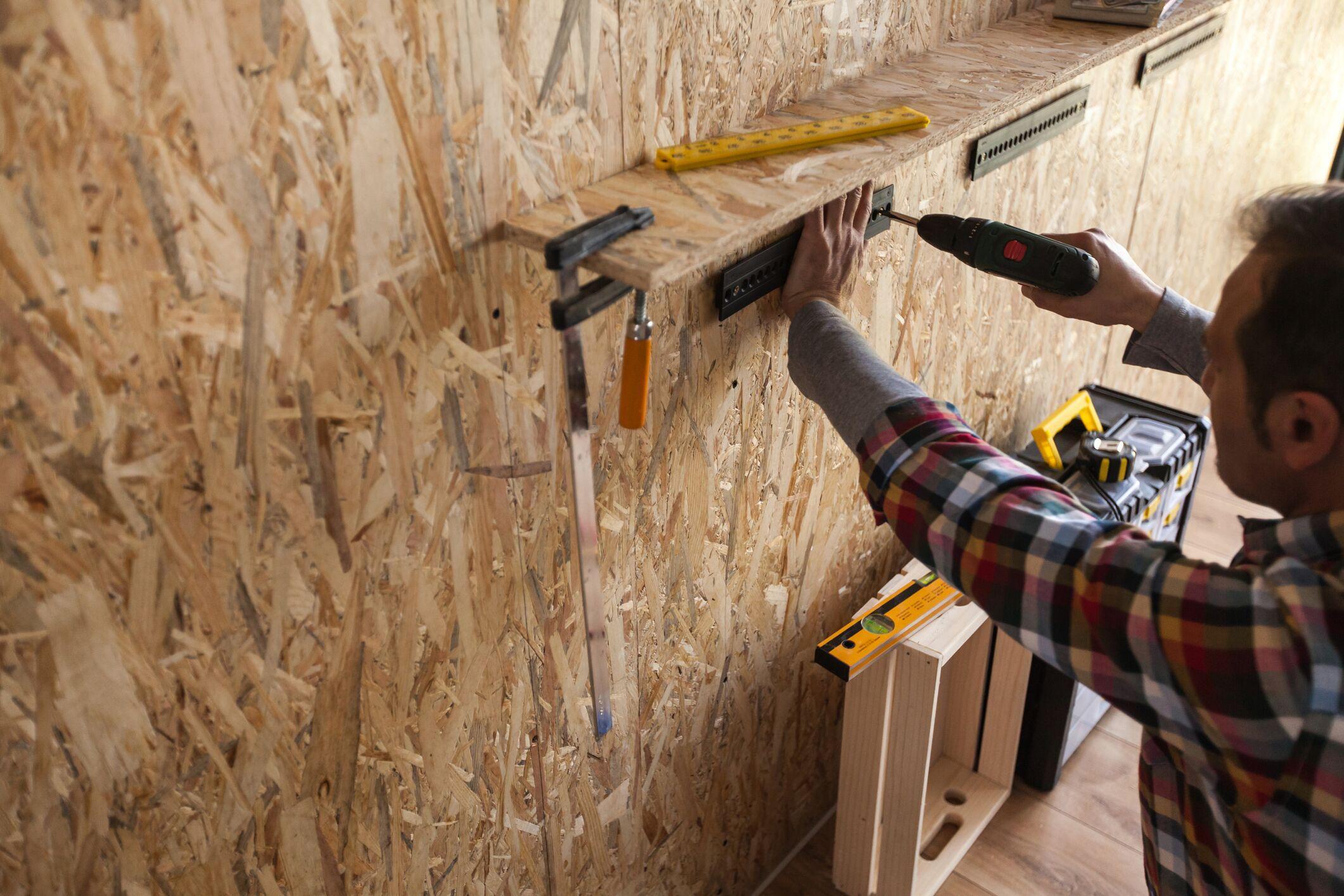 installing new shelves to organize storage in a garage