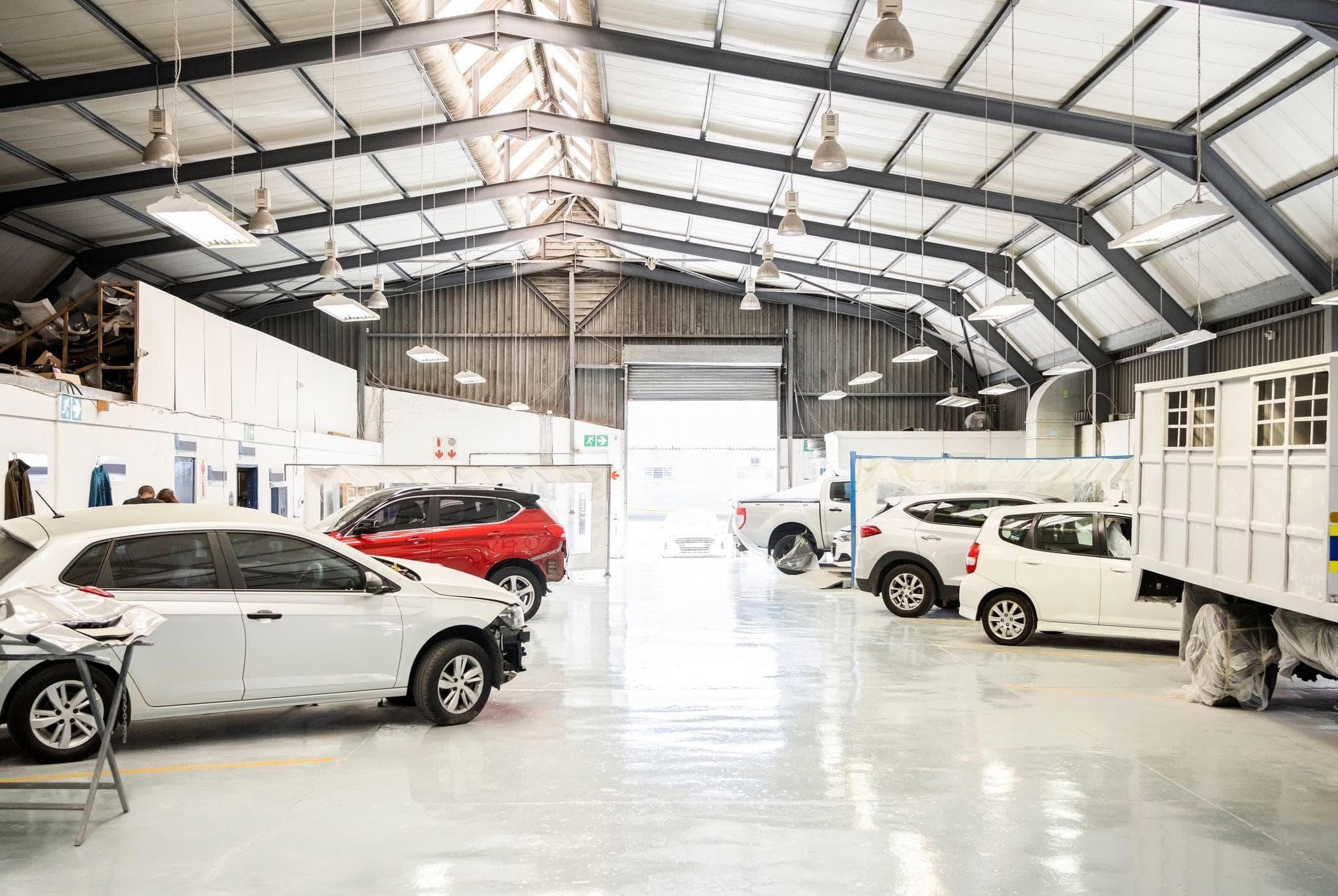 interior of an auto dealership service center with commercial overhead doors