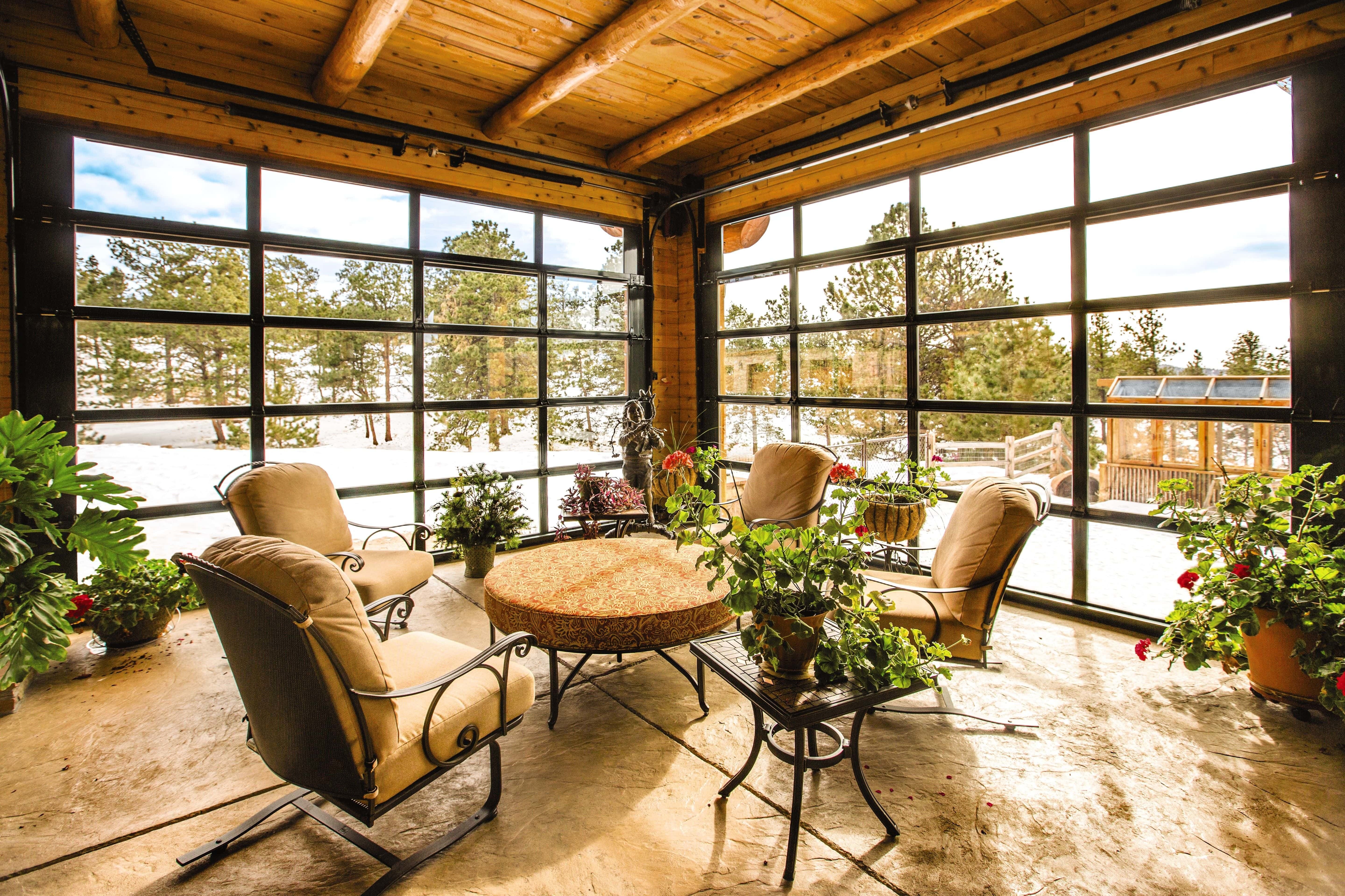 interior of sunroom that has been transformed with glass garage doors