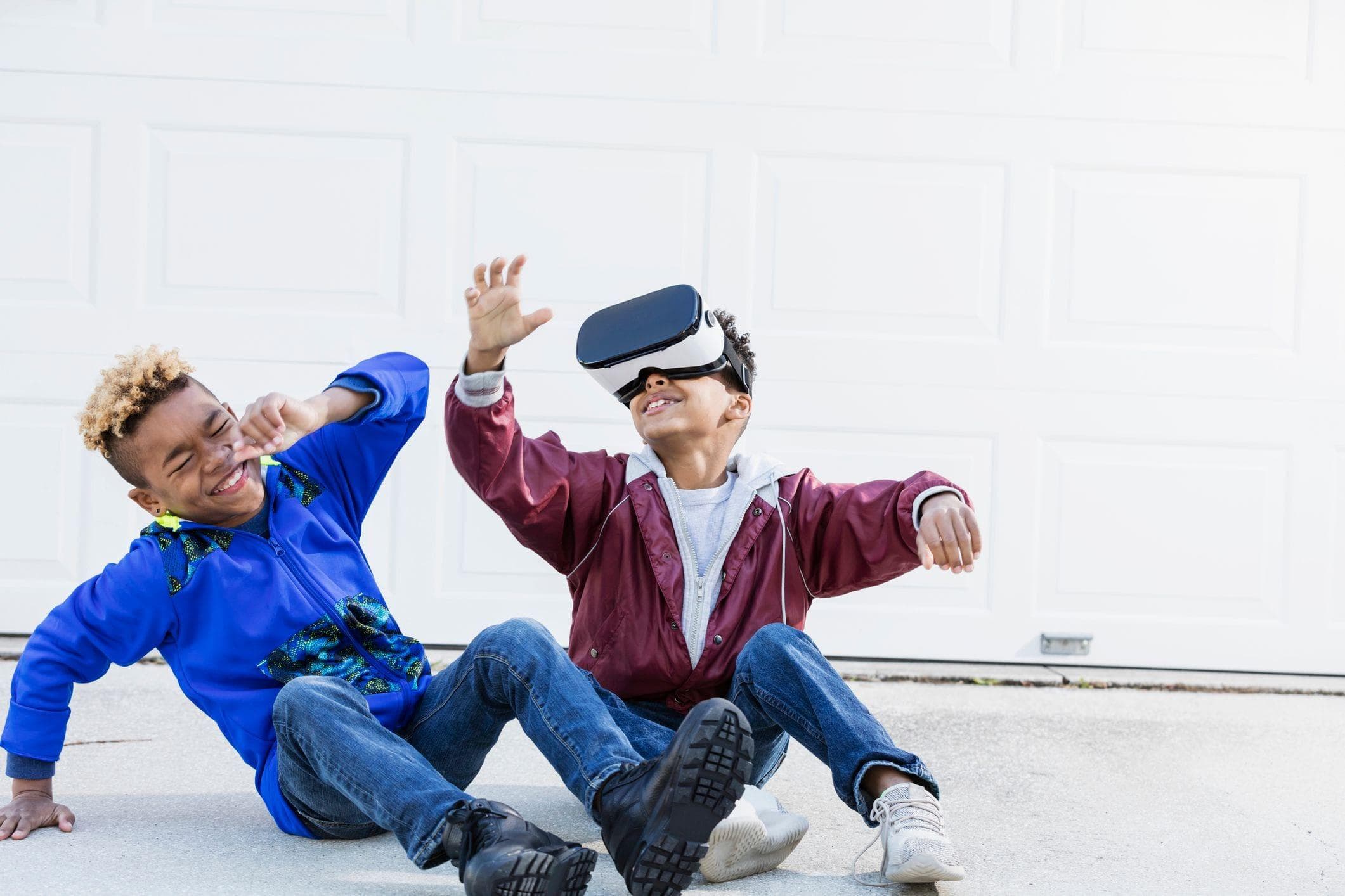 kids playing with a VR headset in garage