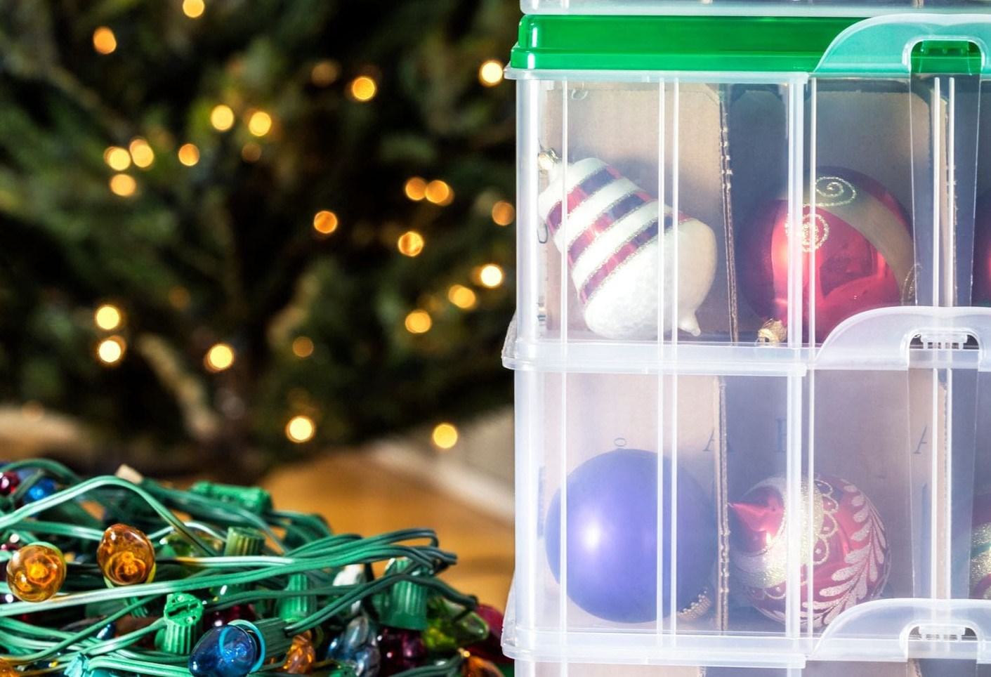 organizing lights and ornaments in clear plastic bins