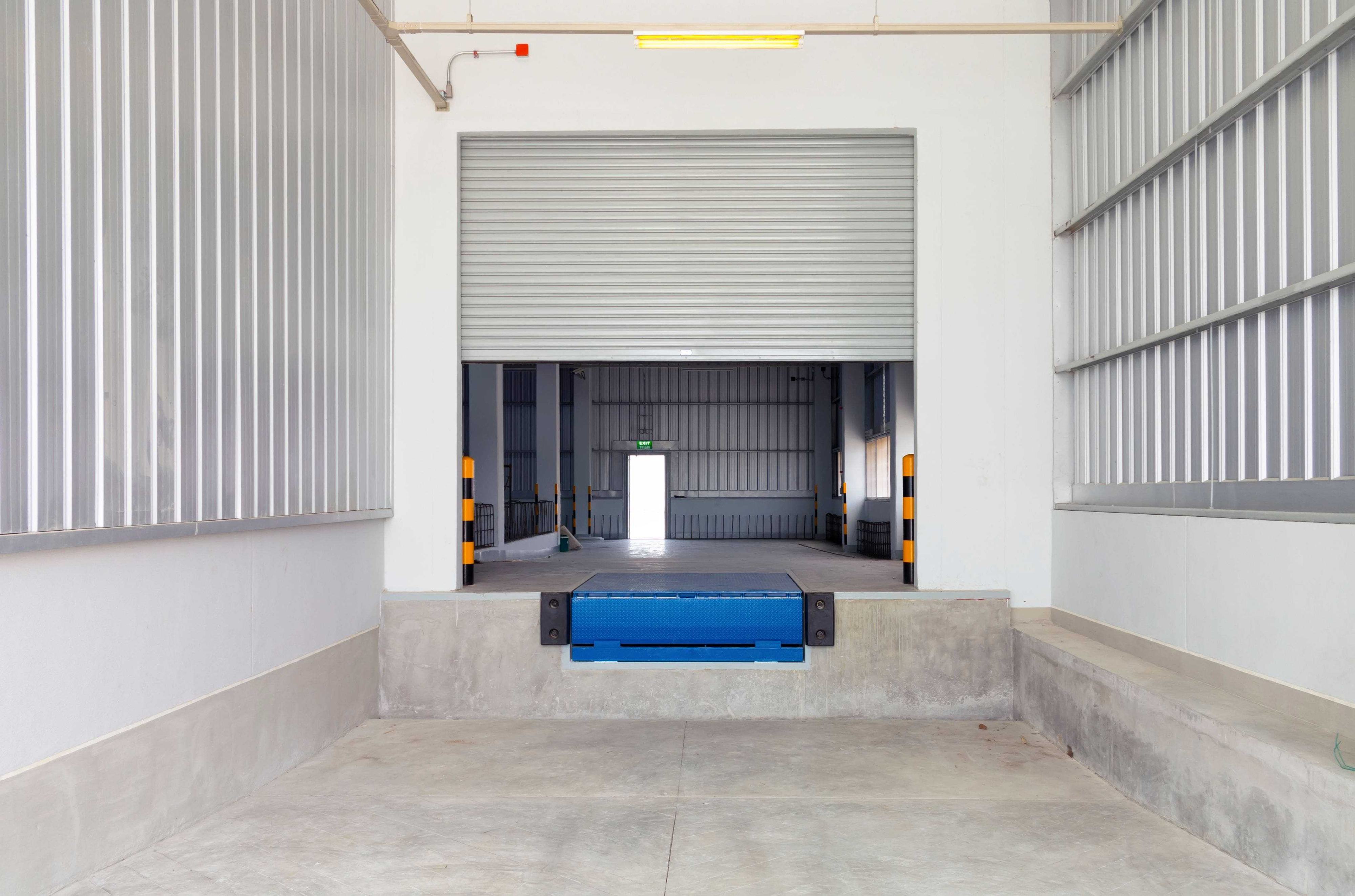 interior of loading dock with leveler and steel door interior of loading dock with leveler and steel door