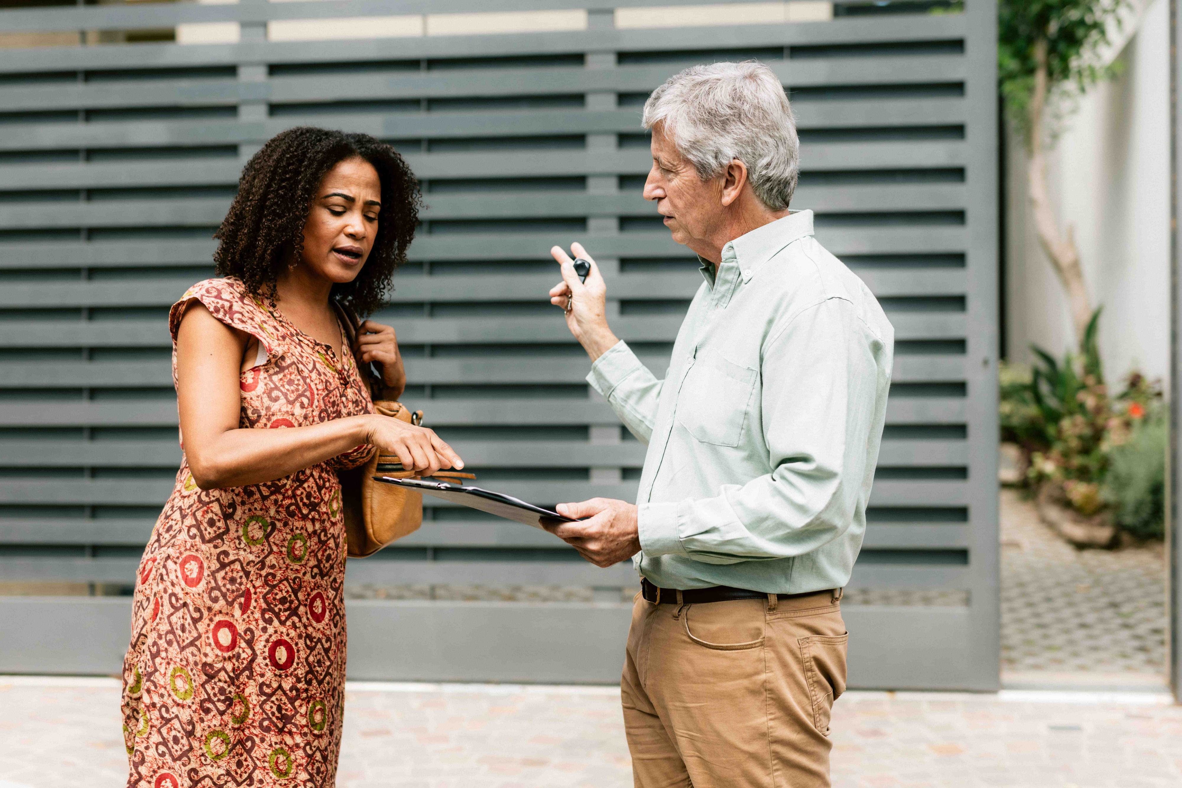 landlord discussing garage door and gate with new tenant landlord discussing garage door and gate with new tenant