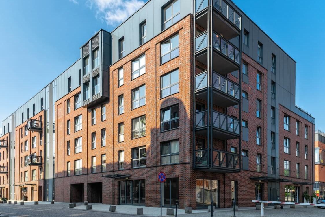 old brick building retrofitted with new pedestrian doors