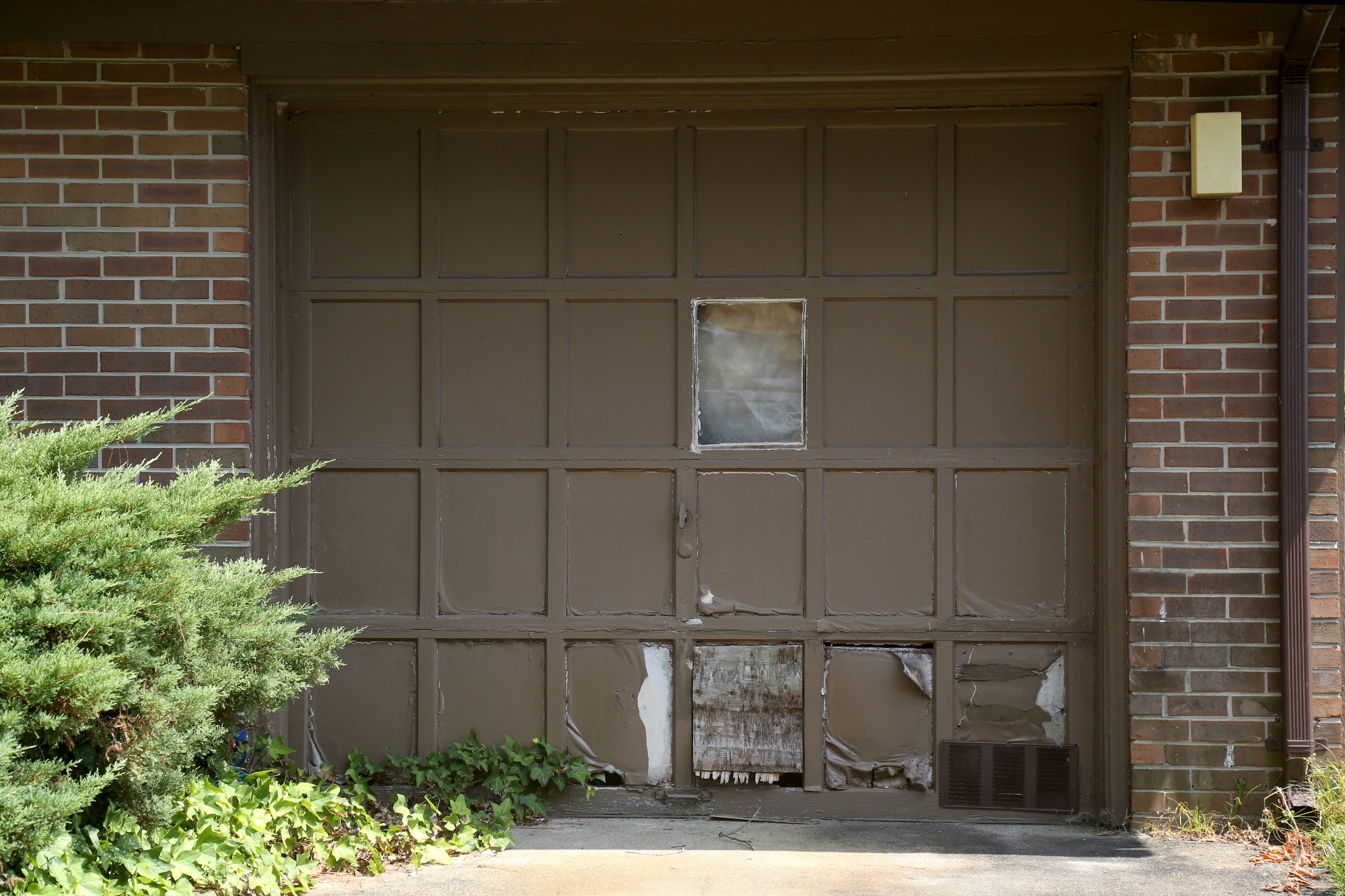 Old cracked and damaged garage door panels