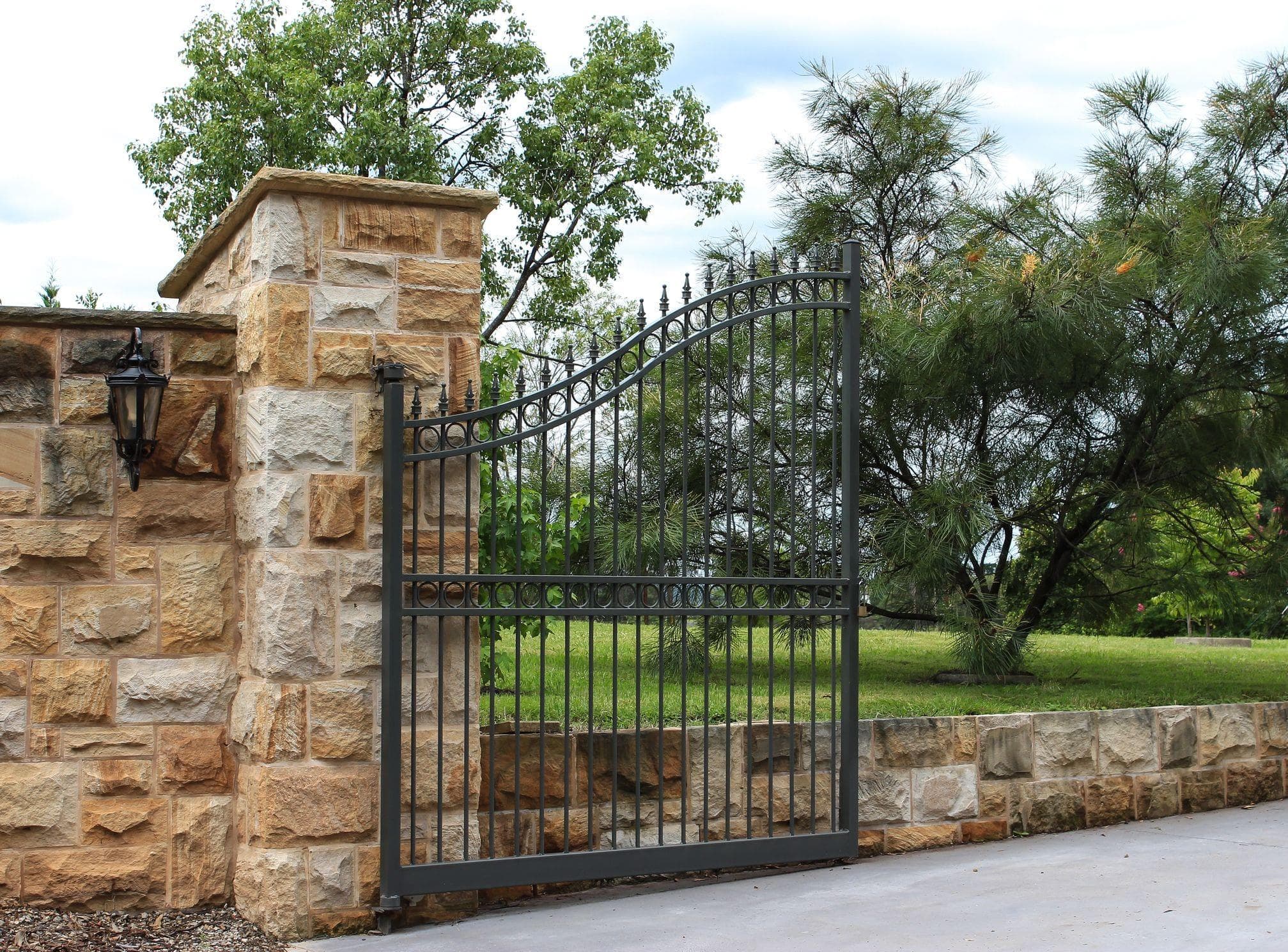 brick and metal residential gate open