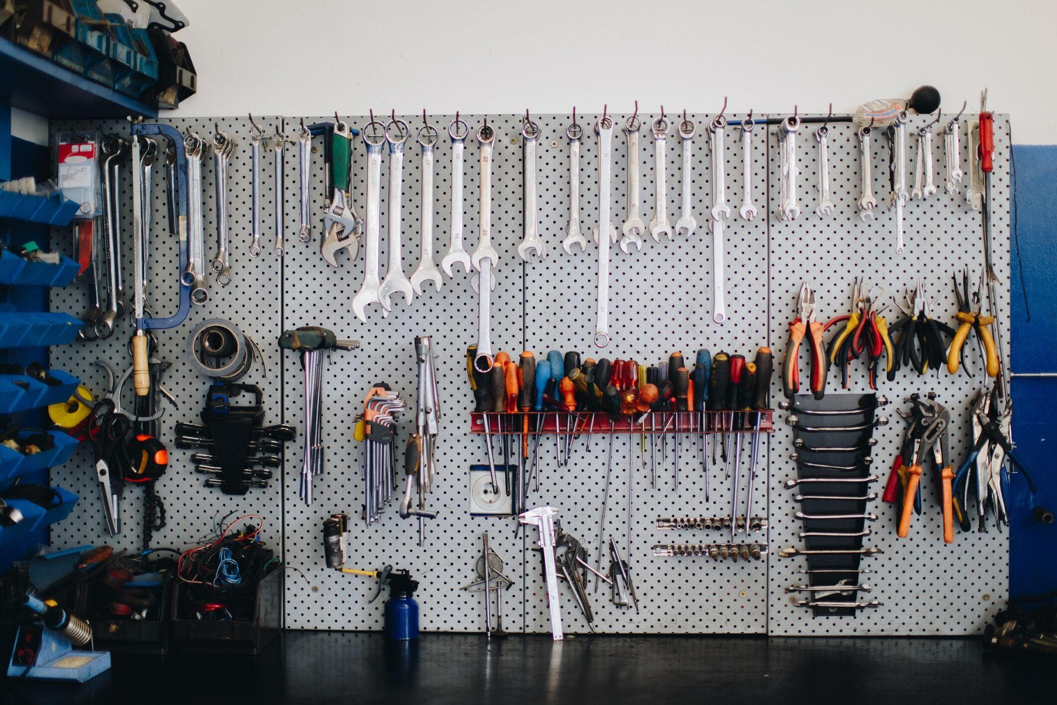 clean and organized tools hanging on a pegboard with hooks
