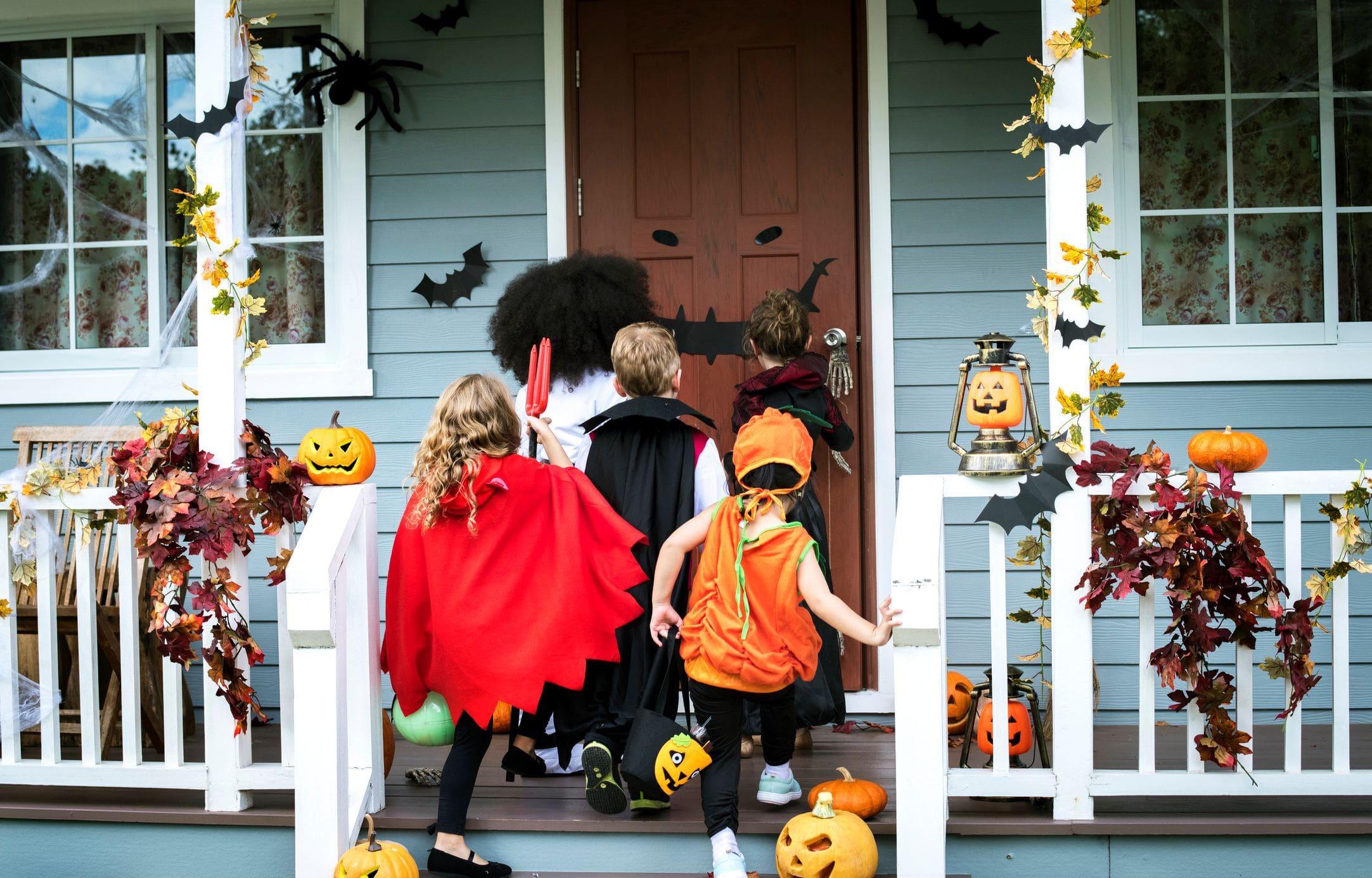 trick or treaters standing on well decorated front porch trick or treaters standing on well decorated front porch